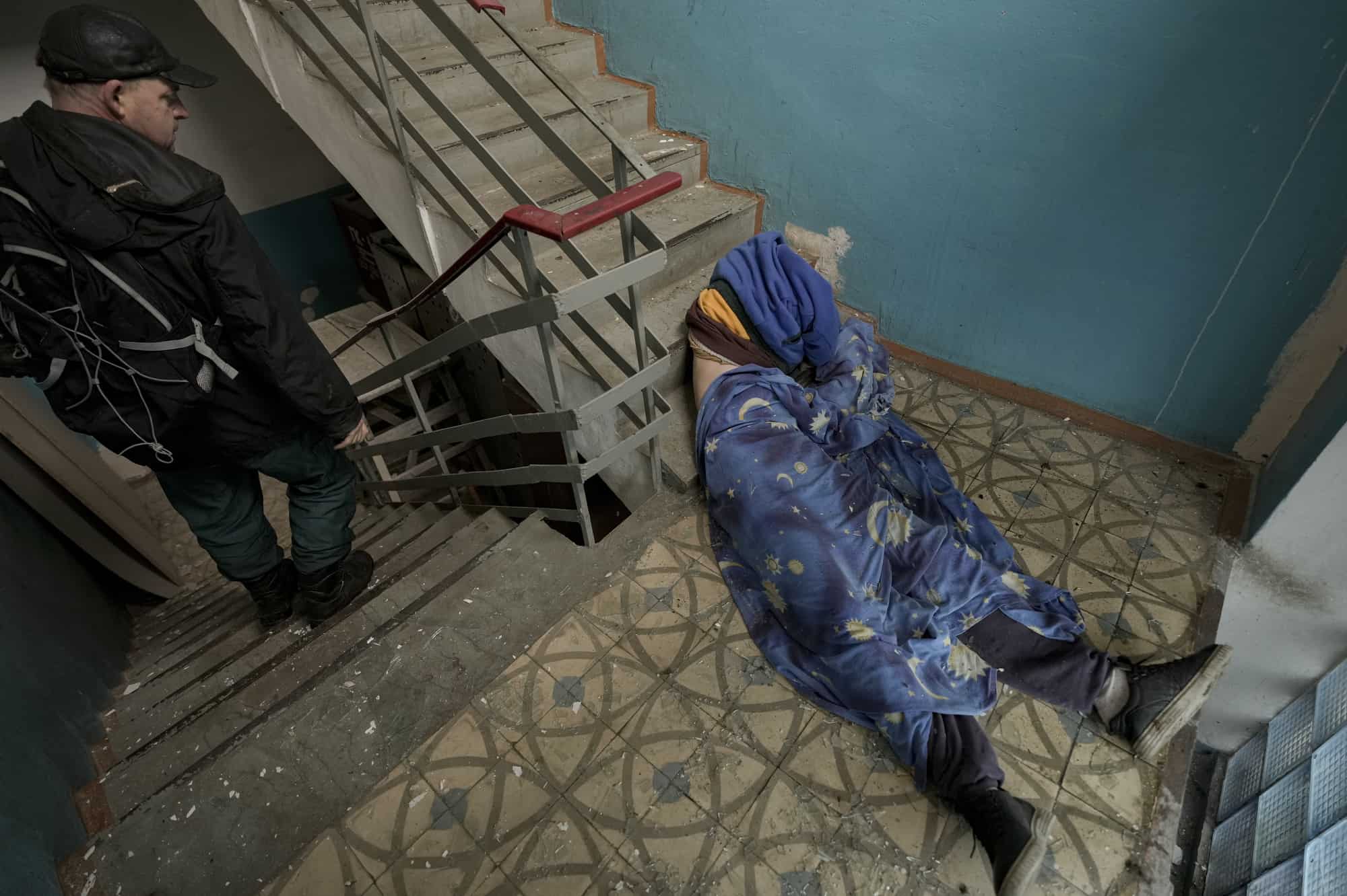 El cuerpo sin vida de un hombre se ve tumbado en la escalera de un edificio en Bucha, Ucrania, el domingo 3 de abril de 2022.