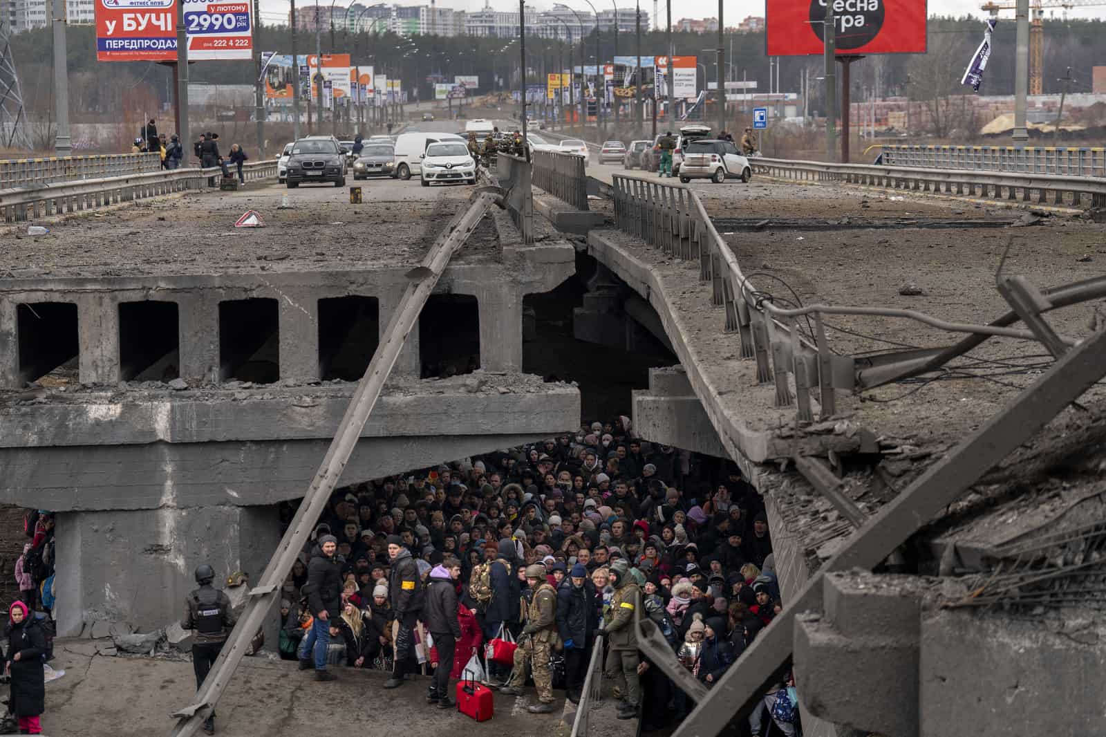 Archivo - Decenas de ucranianos se amontonan debajo de un puente destruido mientras intentan huir cruzando el río Irpin el 5 de marzo de 2022, en las afueras de Kiev, Ucrania.