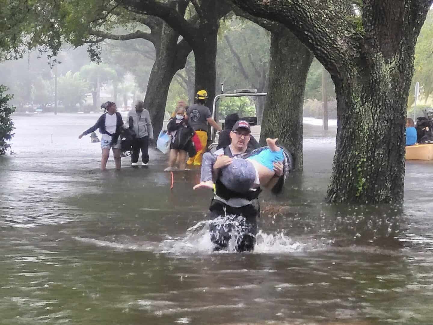 En esta foto proporcionada por la Oficina de Información Pública del Cuerpo de Bomberos del Condado de Orange, los bomberos del Condado de Orange ayudan a las personas atrapadas por el huracán Ian la madrugada del jueves 29 de septiembre de 2022 en el Condado de Orange, Florida.