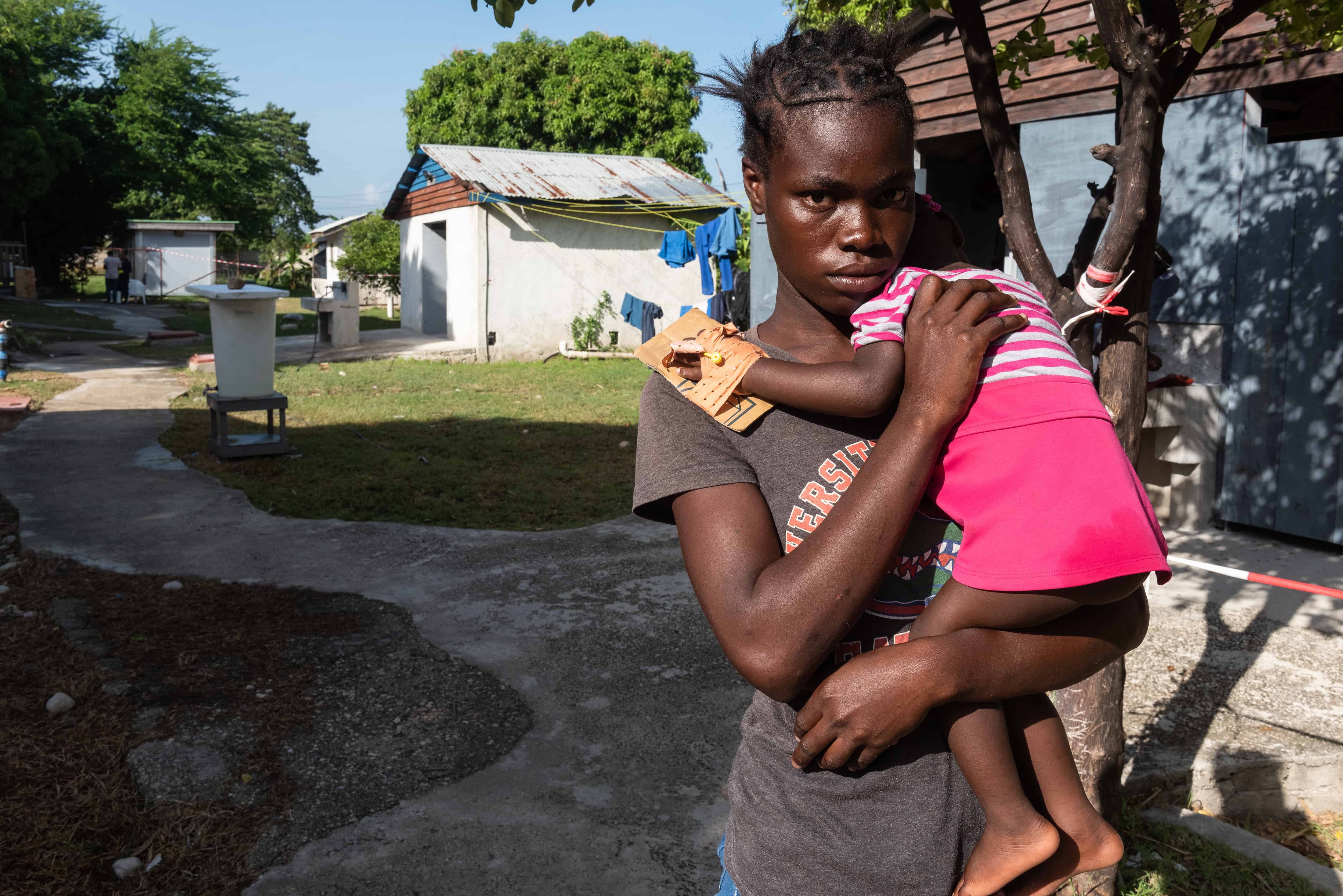 Una joven carga a su hija con cólera en el Centro de Tratamiento del Cólera (CTC) de Médicos Sin Fronteras (MSF) en el barrio de Cité-Soleil ayer, en Puerto Príncipe (Haití). 