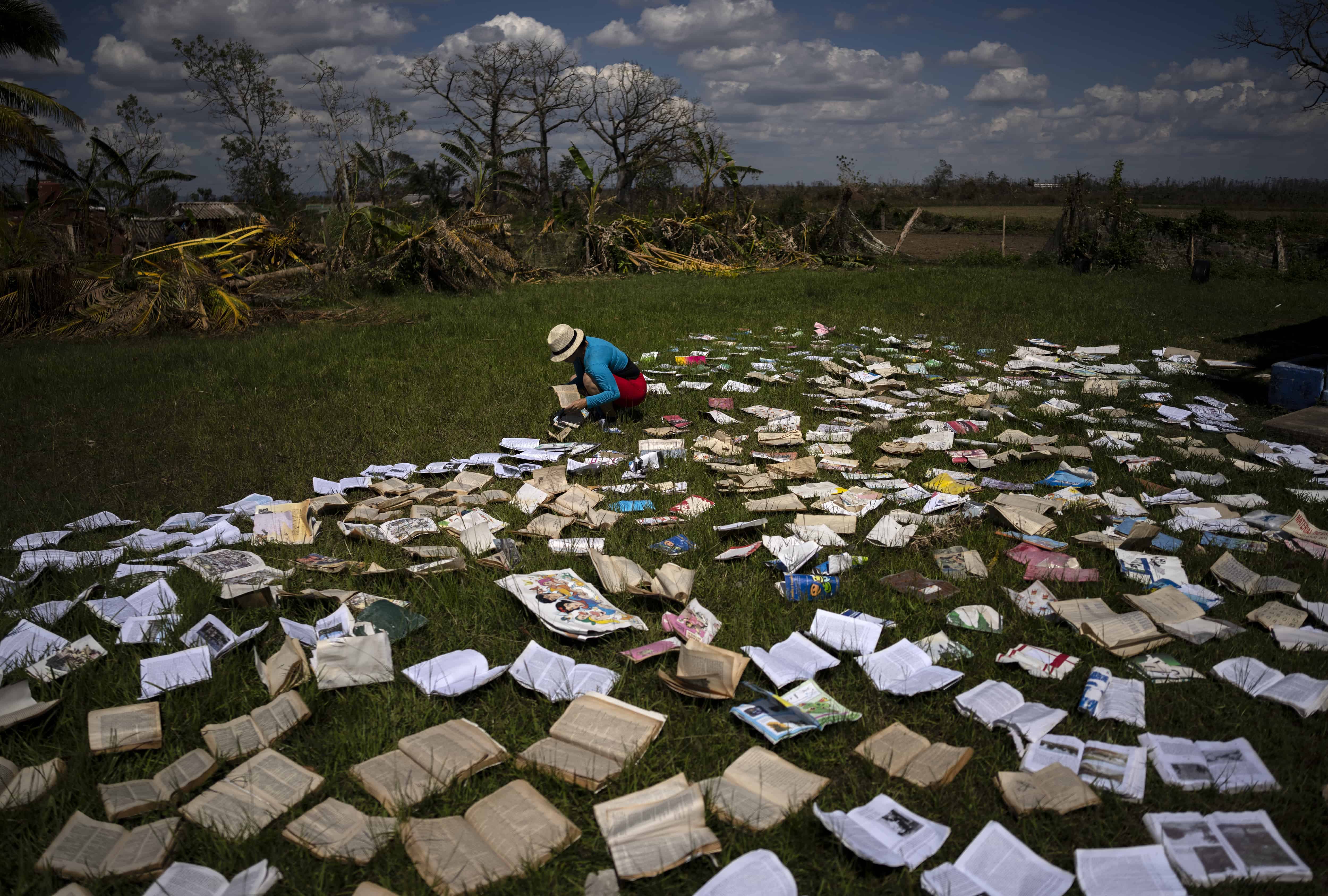 Una profesora seca los libros de una escuela que resultó fuertemente afectada por el huracán Ian en La Coloma, en la provincial de Pinar del Río, Cuba, el miércoles 5 de octubre de 2022.