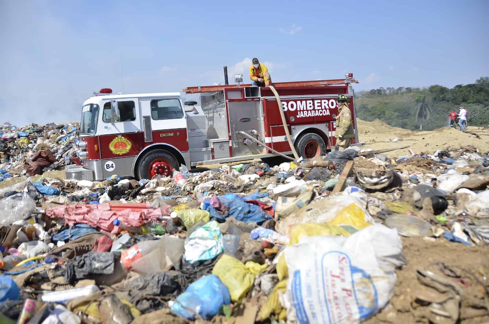 Bomberos durante las labores de extinción del incendio en el vertedero de Jarabacoa.
