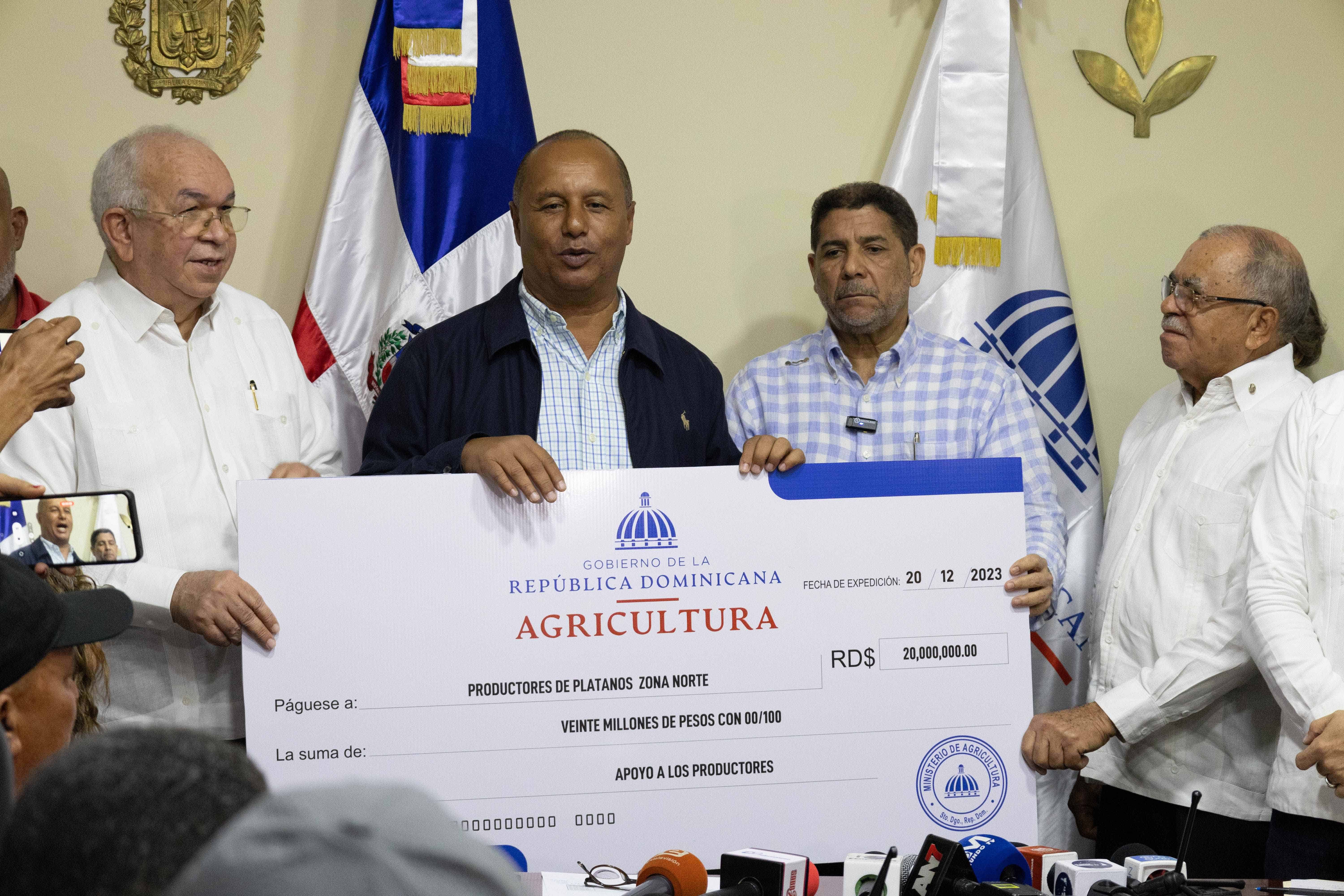 El viceministro de Producción y Mercadeo, Eulalio Ramírez, sostuvo el cheque simbólico que le será entregado a los productores de banano del norte.