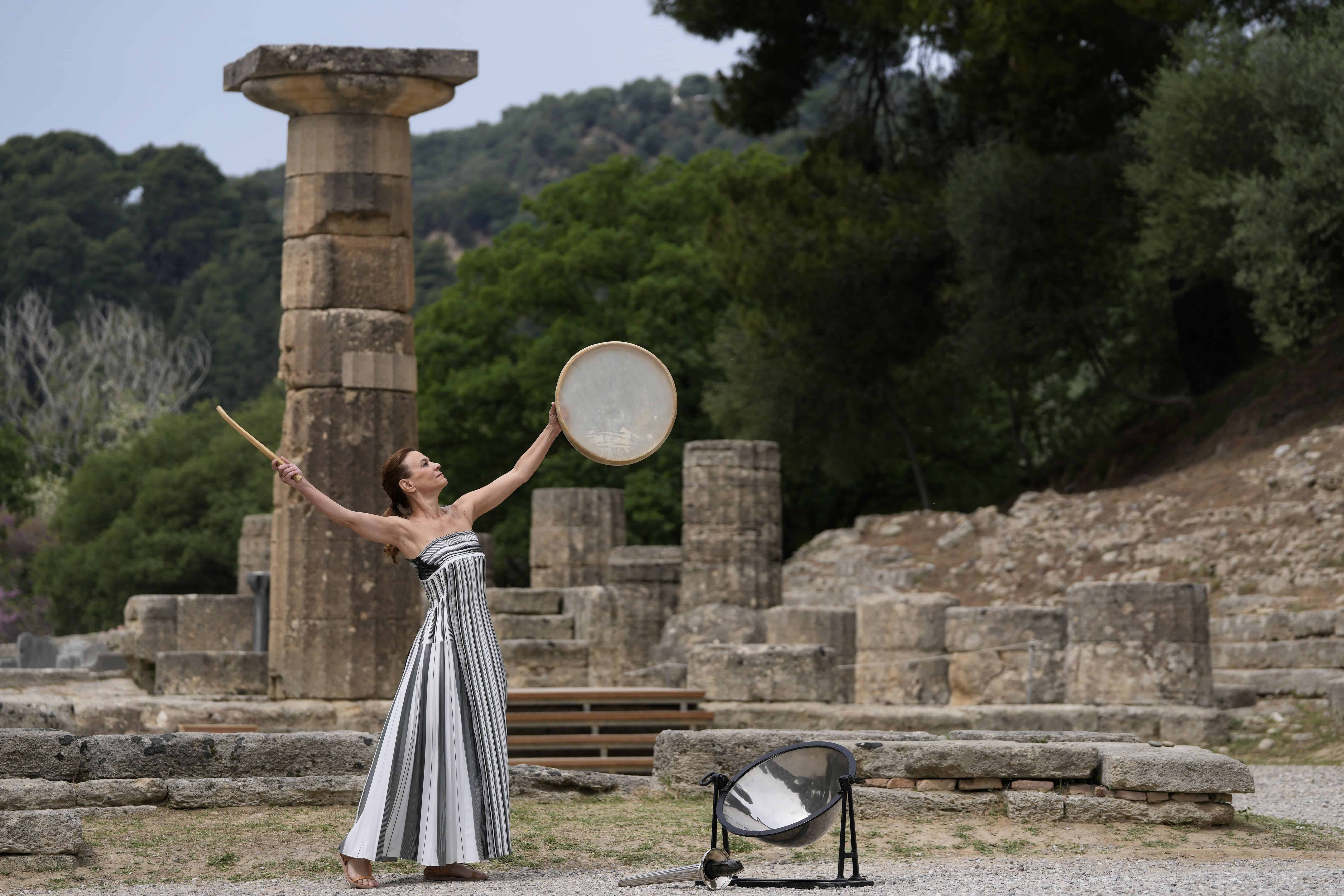 Un artista participa en la ceremonia oficial de encendido de la llama de los Juegos Olímpicos de París, en el sitio de la Antigua Olimpia, Grecia.