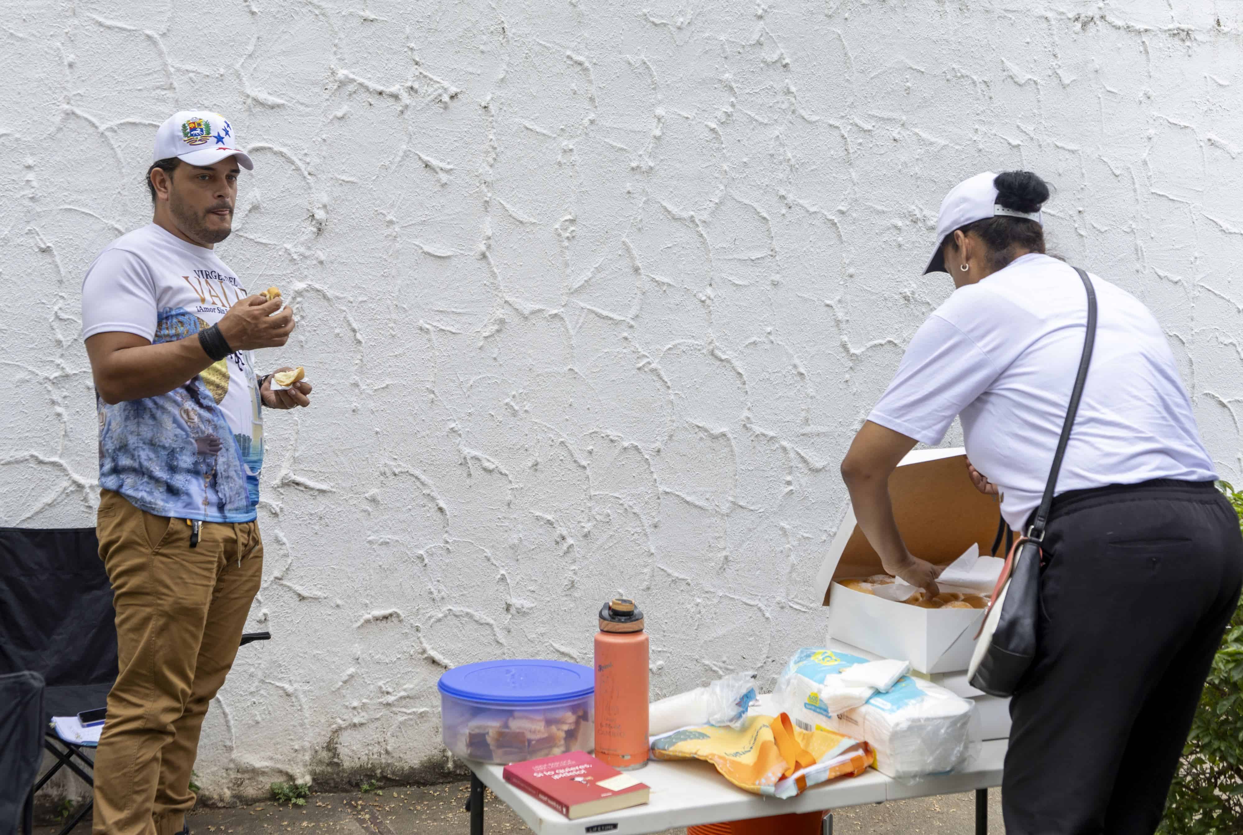 Un grupo de voluntarios venezolanos instalaron una estación afuera de la embajada con alimentos y agua para sus compatriotas.