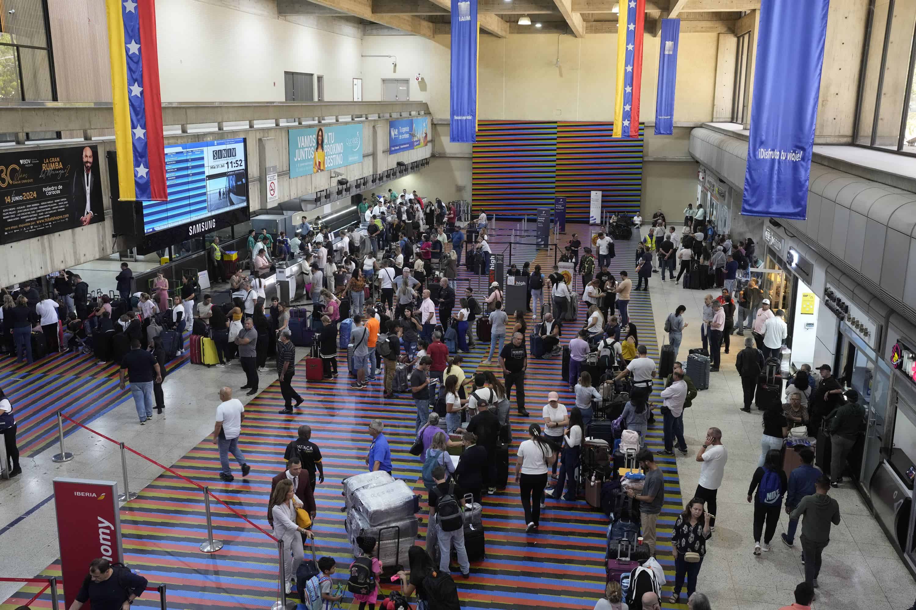 Gente buscando vuelos en el Aeropuerto Internacional Simón Bolivar en Maiquetia, junto a Caracas, Venezuela, el miércoles 31 de julio de 2024, tres días después de unas controvertidas elecciones presidenciales. Venezuela suspendió los vuelos hacia República Dominicana y Panamá.