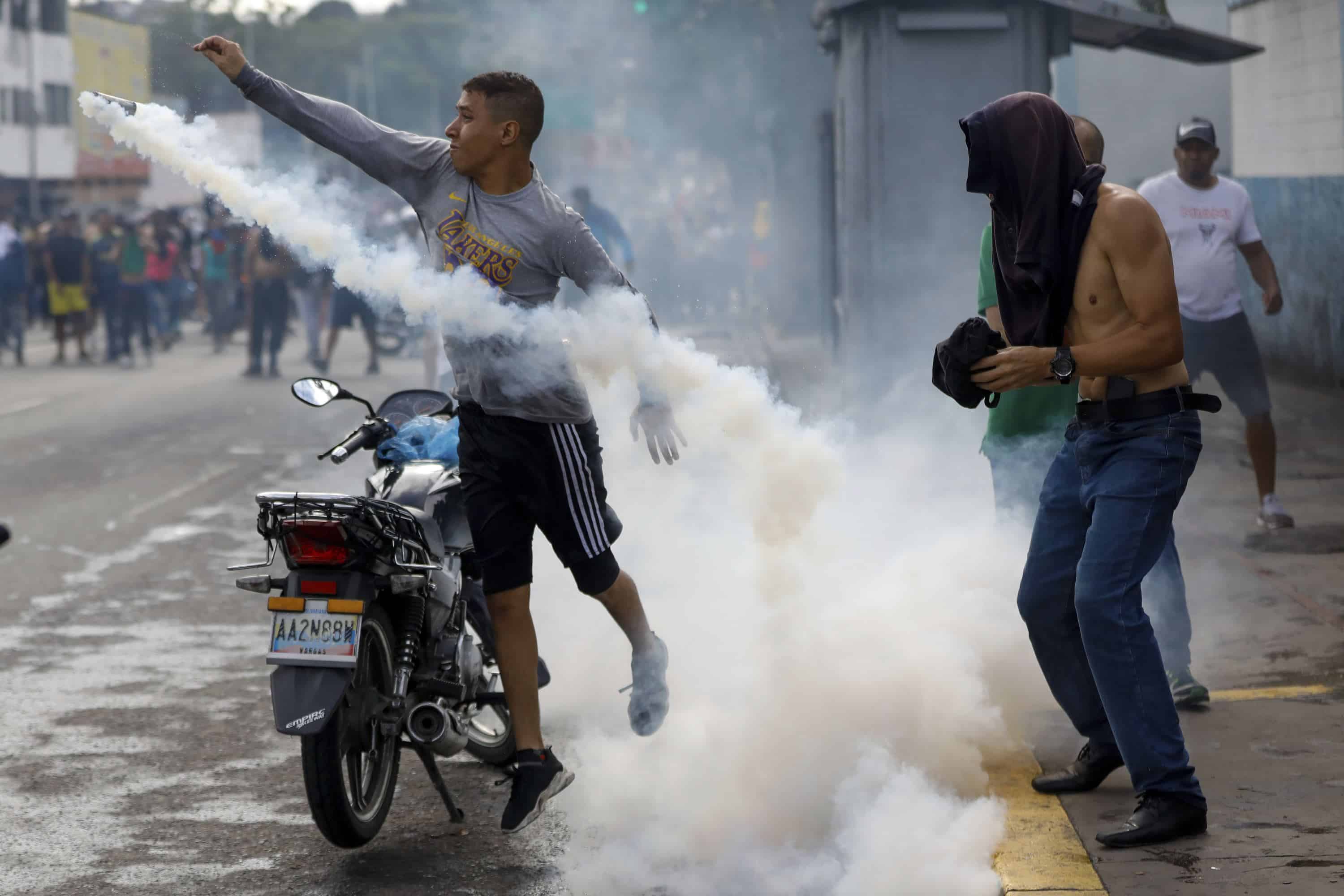 Un manifestante arroja una bombona de gas a la policía durante las manifestaciones contra los resultados oficiales de las elecciones que declaran la reelección del presidente Nicolás Maduro, el día después de la votación, en Caracas, Venezuela, el lunes 29 de julio de 2024.