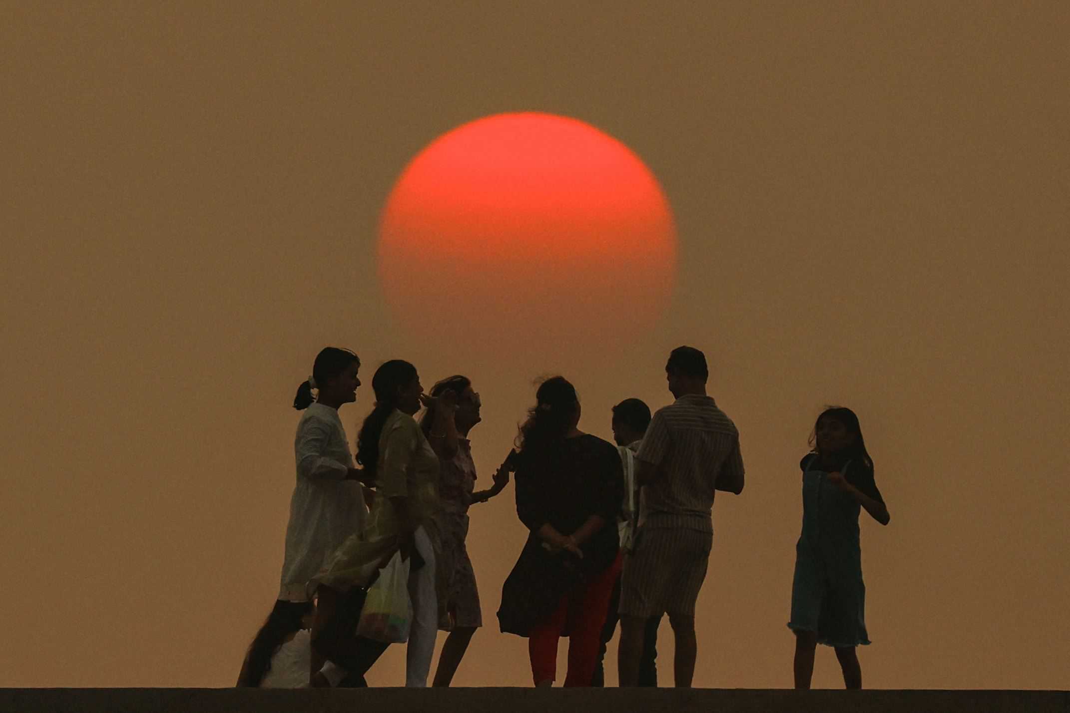 La gente disfruta de la última puesta de sol del año en la víspera de Año Nuevo en la playa de Gorai, a lo largo de la costa del mar Arábigo, en las afueras de Mumbai, India, el 31 de diciembre de 2024.