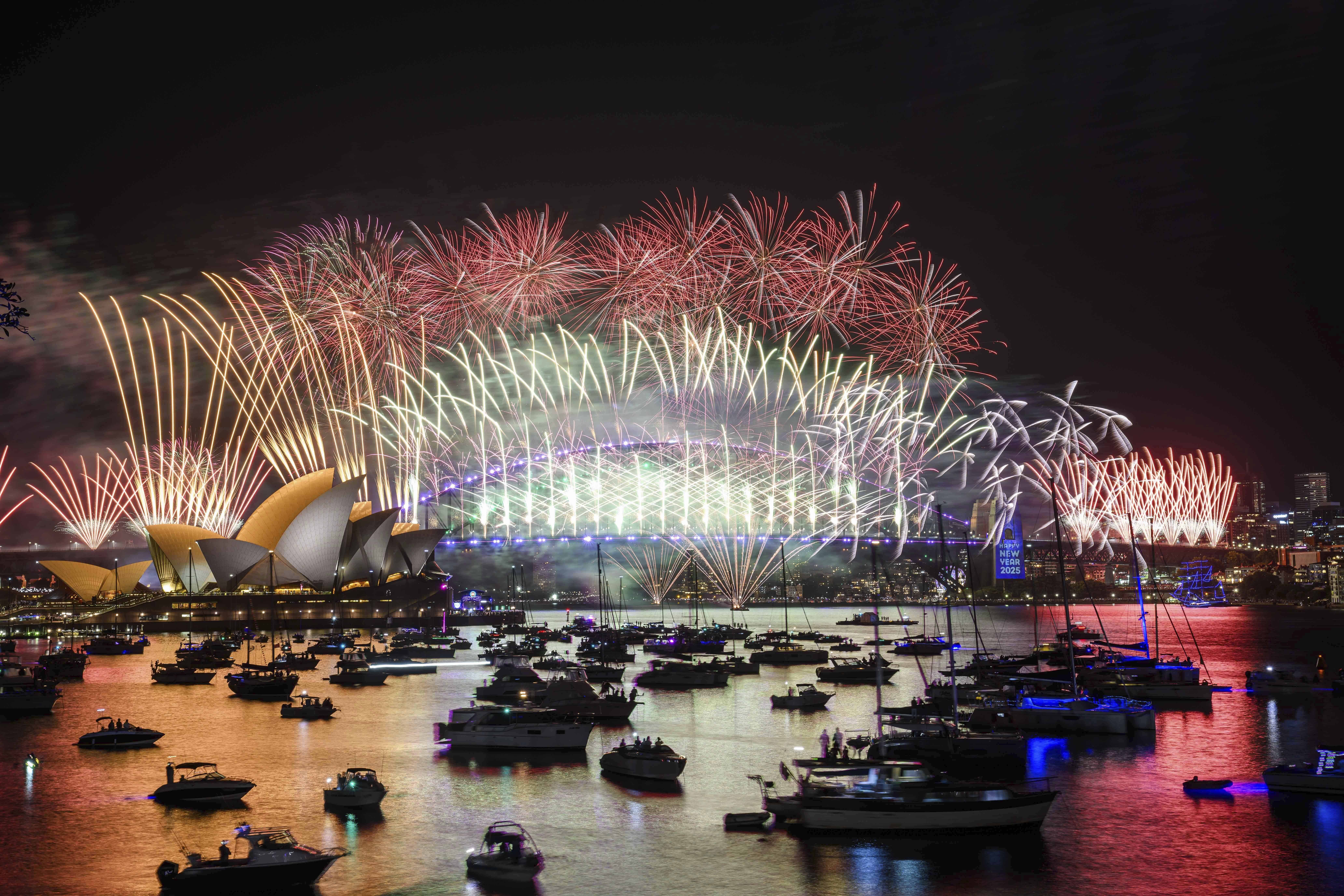 Los fuegos artificiales estallan sobre la Ópera de Sídney y el Puente del Puerto durante las celebraciones de Nochevieja en Sídney, el martes 31 de diciembre de 2024.