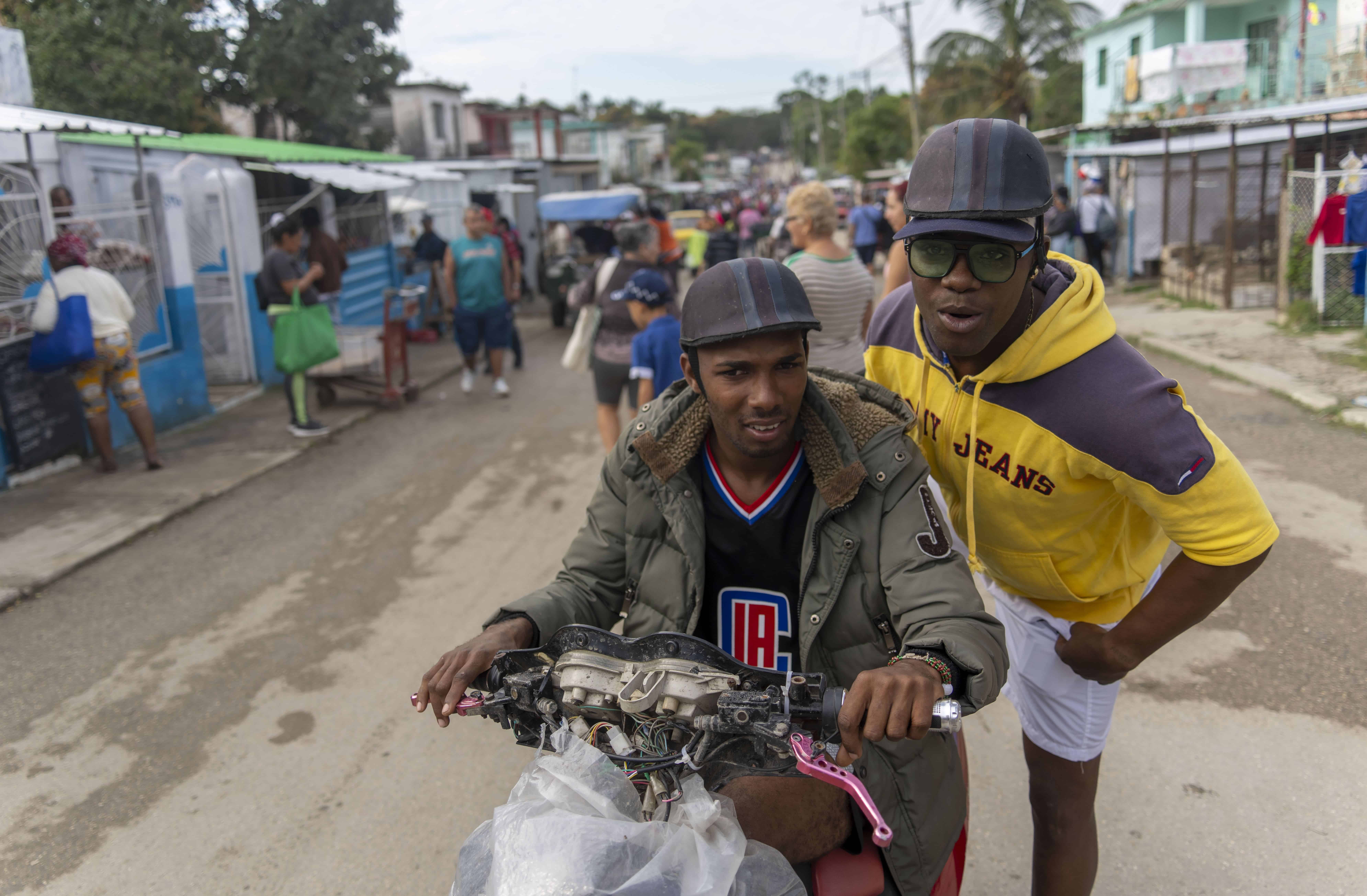 Juan Yainier Antomarchi Núñez se sube a la parte trasera de un taxi en motocicleta en La Habana, Cuba, el jueves 16 de enero de 2025, después de ser liberado condicionalmente de la detención por participar en las protestas antigubernamentales de 2021.