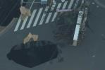 Un camionero japonés atrapado en un socavón que se abrió en medio de la calle
