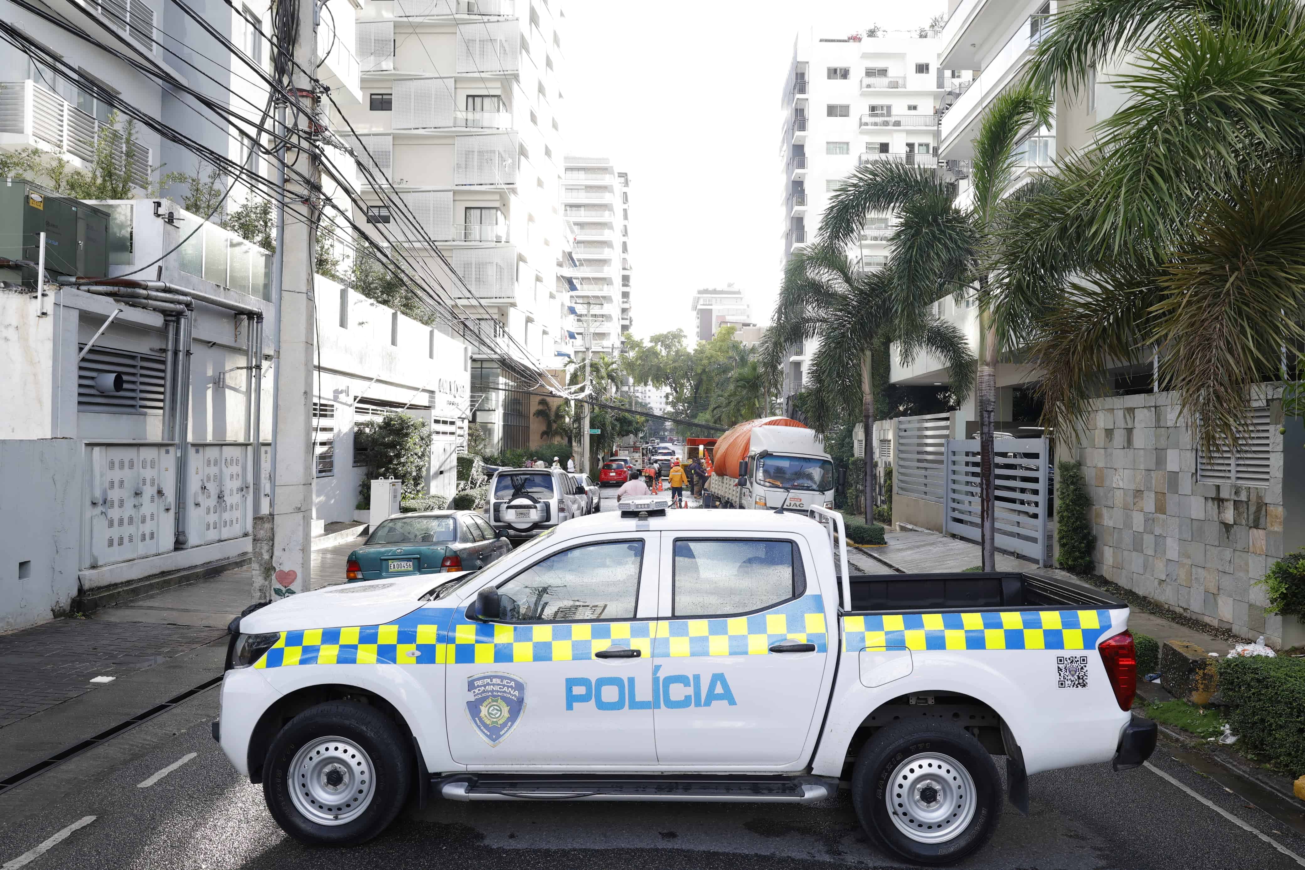 Camioneta de la Policía bloquea el paso de vehículos en la zona donde cayó el árbol. 