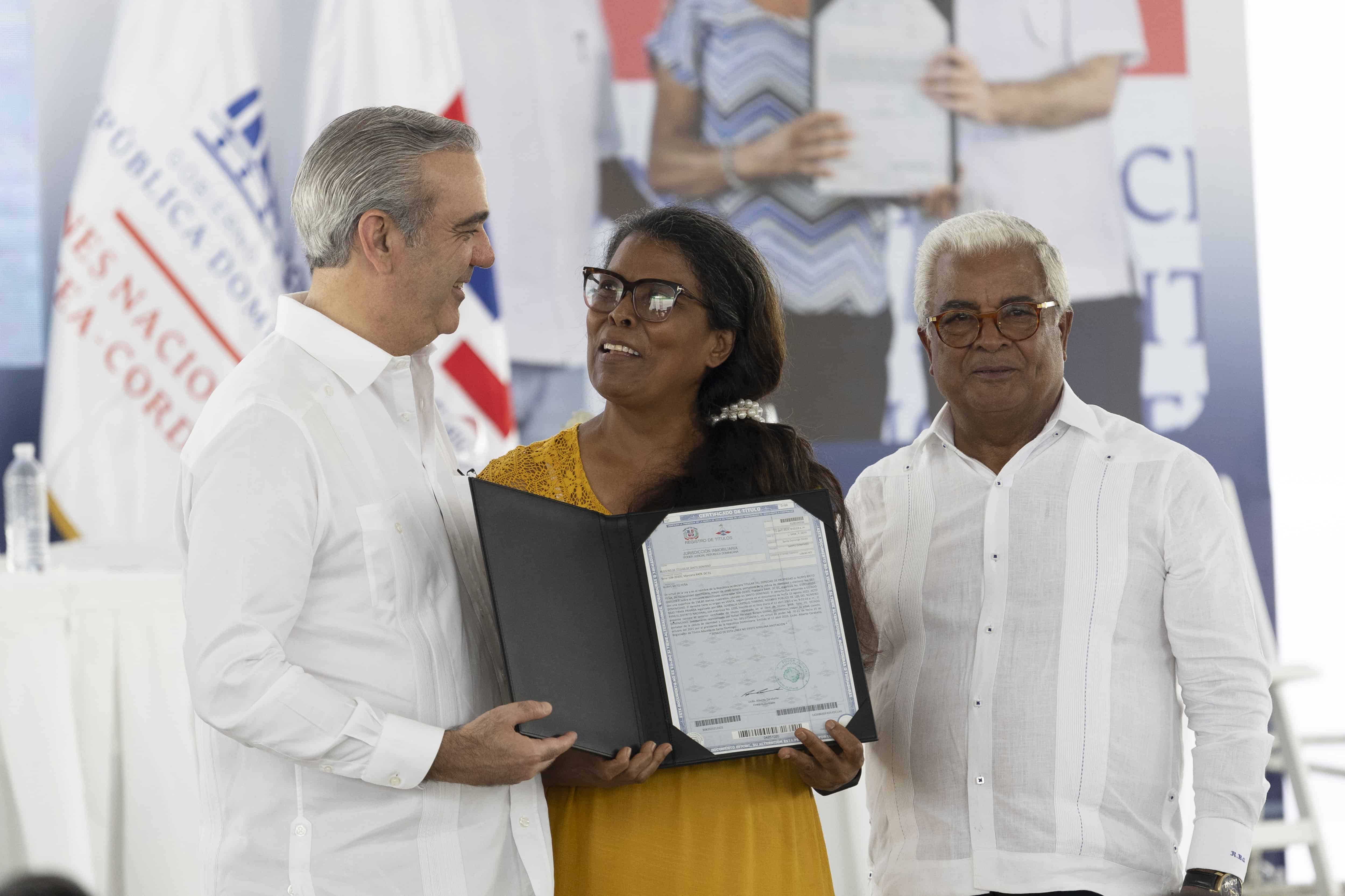 El presidente Luis Abinader (izquierda) y el director de Bienes Nacionales, Rafael Burgos (derecha), en el acto de entrega de 850 títulos de propiedad en el Gran Santo Domingo este 30 de mayo de 2025. 