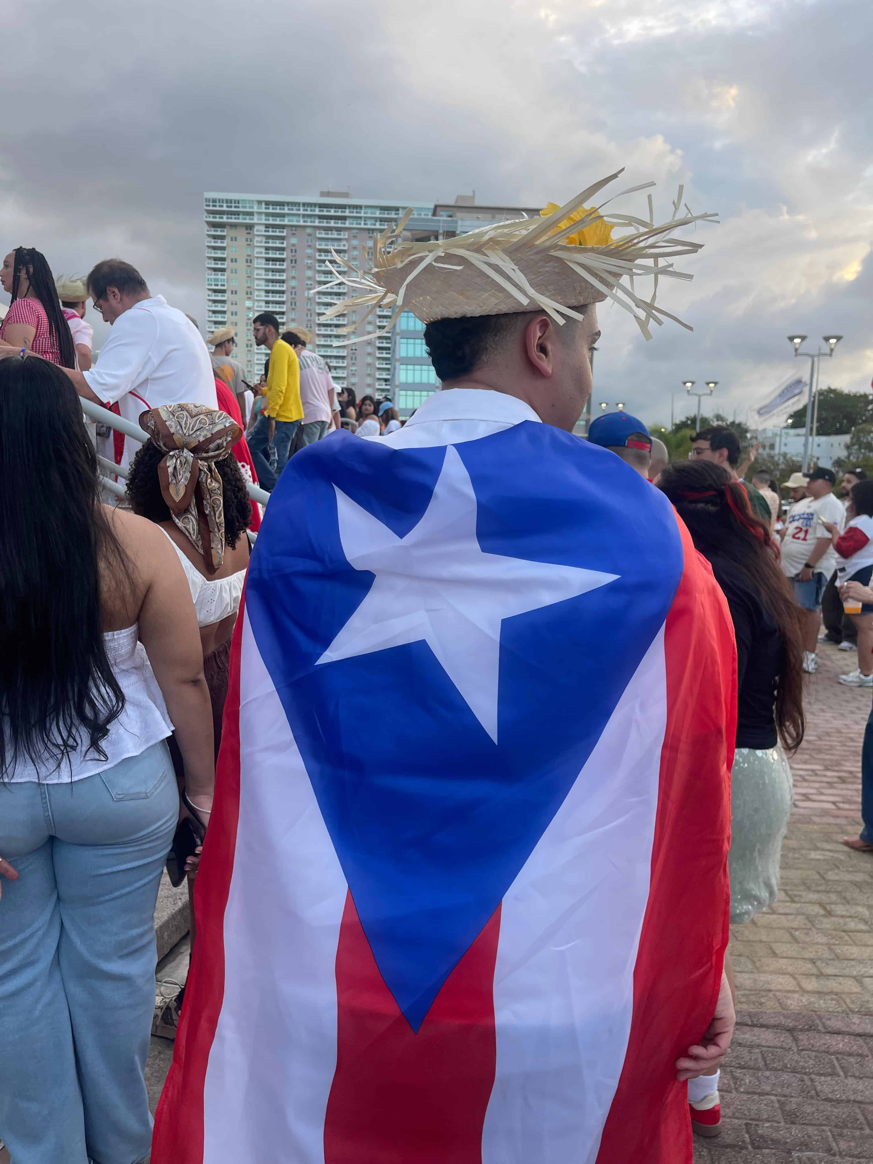 Un joven con la bandera de Puerto Rico ante del inicio del concierto de 