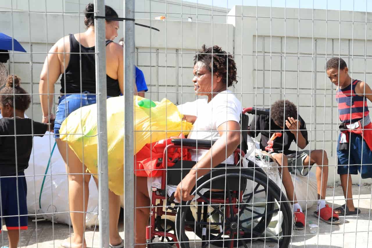 Una mujer con discapacidad haciendo la fila.