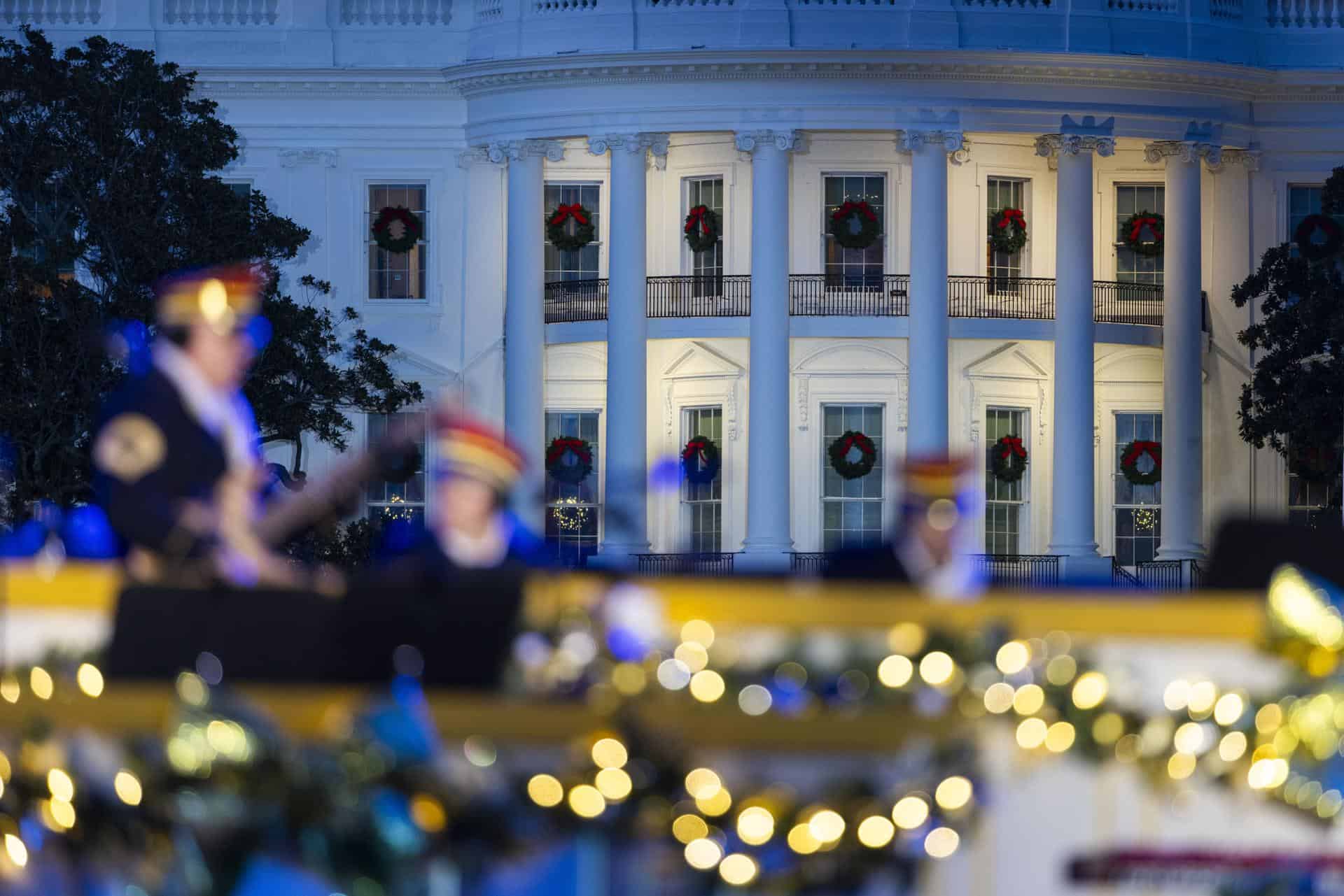 La Casa Blanca se ve tras una banda del Ejército estadounidense antes del encendido del Árbol Nacional de Navidad en la Elipse, frente a la Casa Blanca, en Washington, D. C., EE. UU., el 4 de diciembre de 2025.