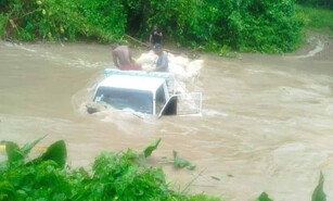 Cami&oacute;n queda atrapado al intentar cruzar arroyo desbordado en El Seibo