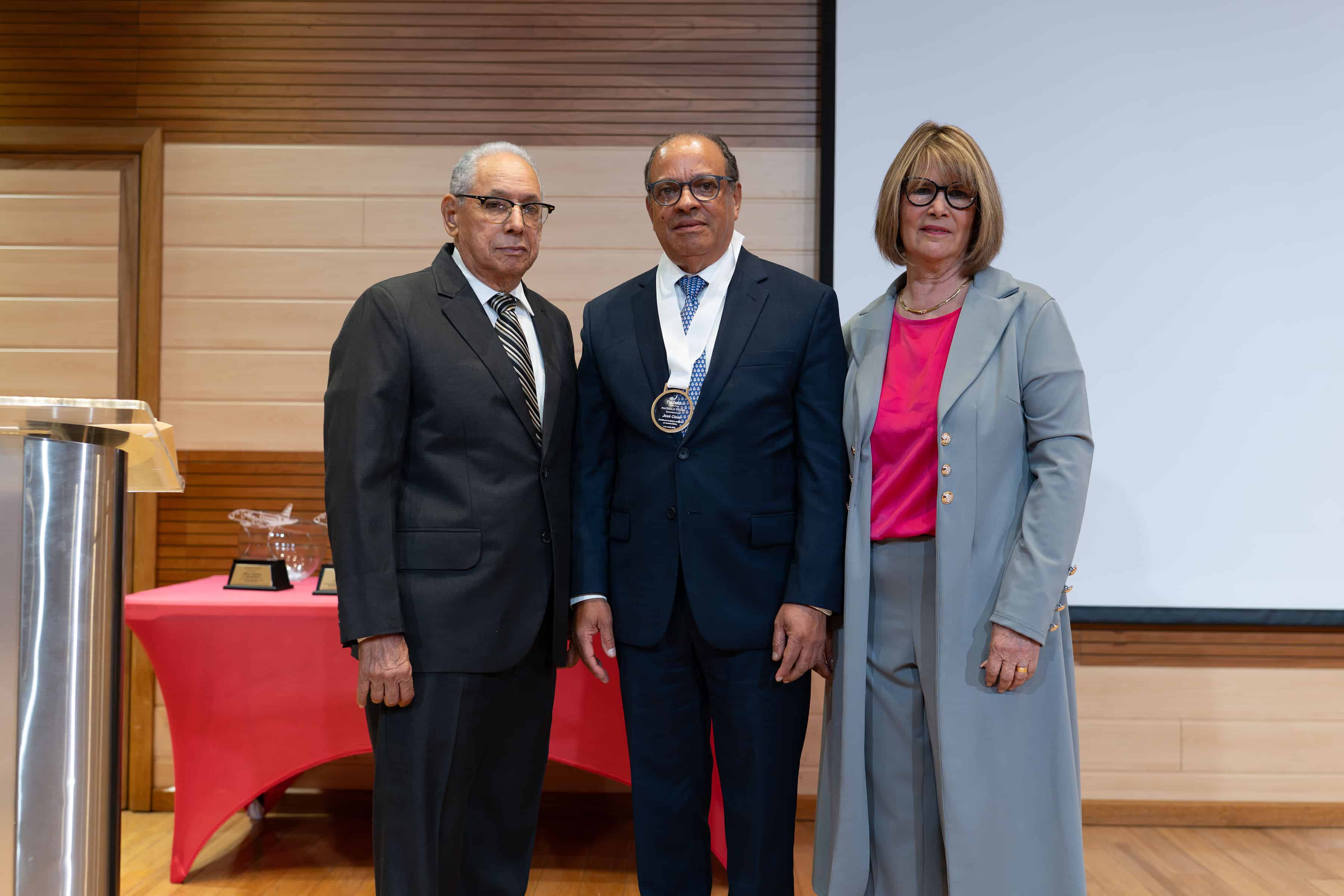 El empresario José Clase recibe una medalla de reconocimiento por sus aportes a la empresa de viajes en estos 40 años.