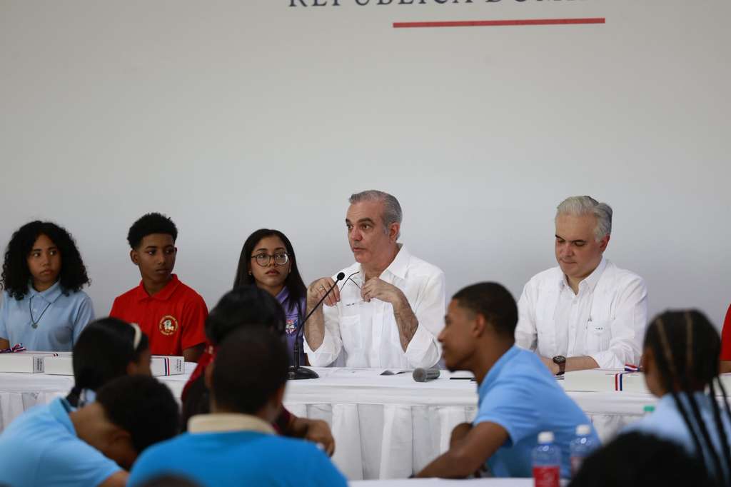 El presidente Luis Abinader (centro) junto al ministro Luis Miguel de Camps durante el encuentro con los estudiantes en la provincia Independencia.