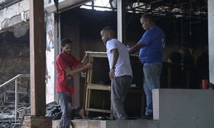 "Todos salimos huyendo": incendio frente a la UASD deja viviendas y negocios destruidos
