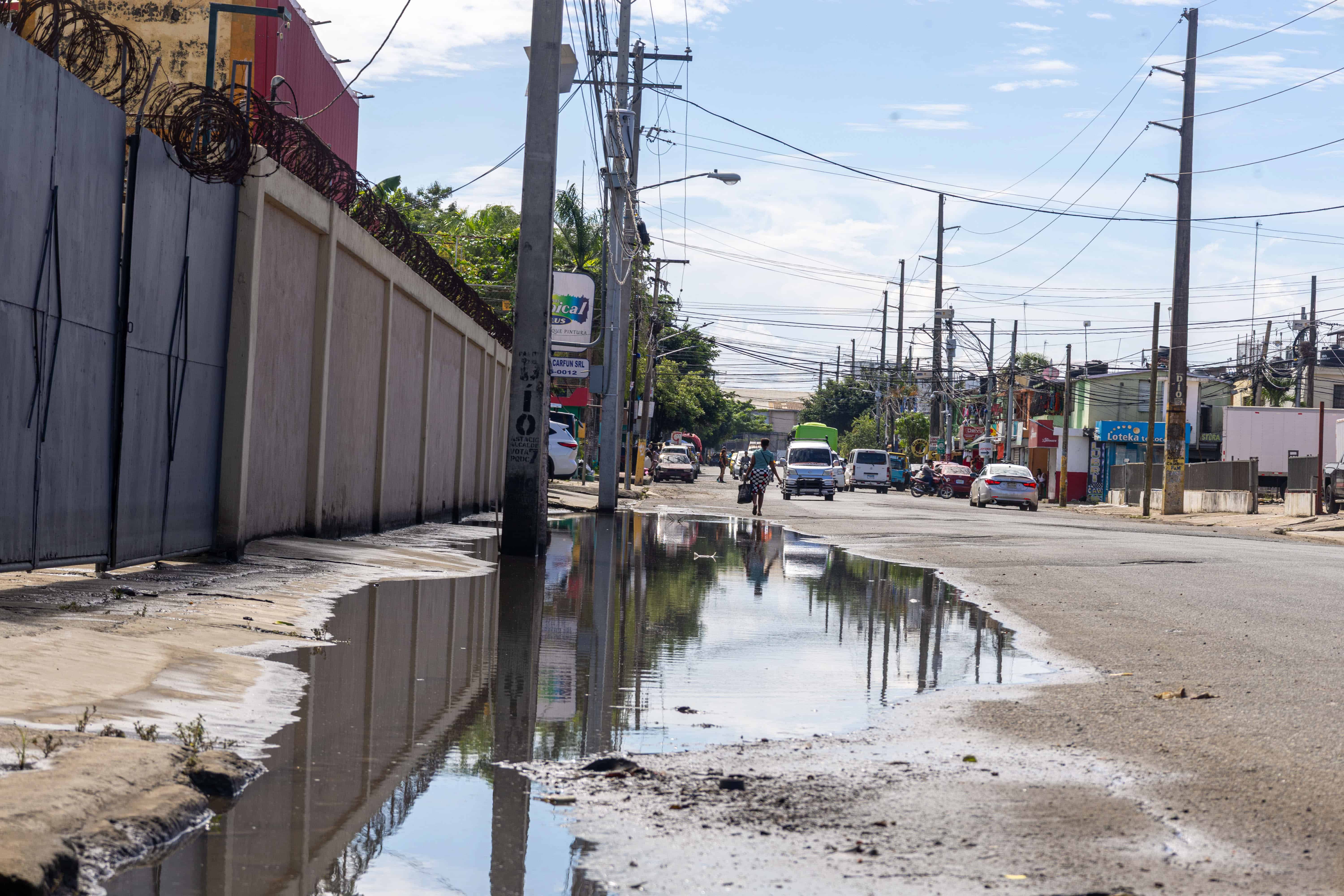 El agua sucia permanec&iacute;a acumulada en parte de la v&iacute;a de entrada al sector El Almirante, en Santo Domingo Este, pese a que su nivel hab&iacute;a disminuido.