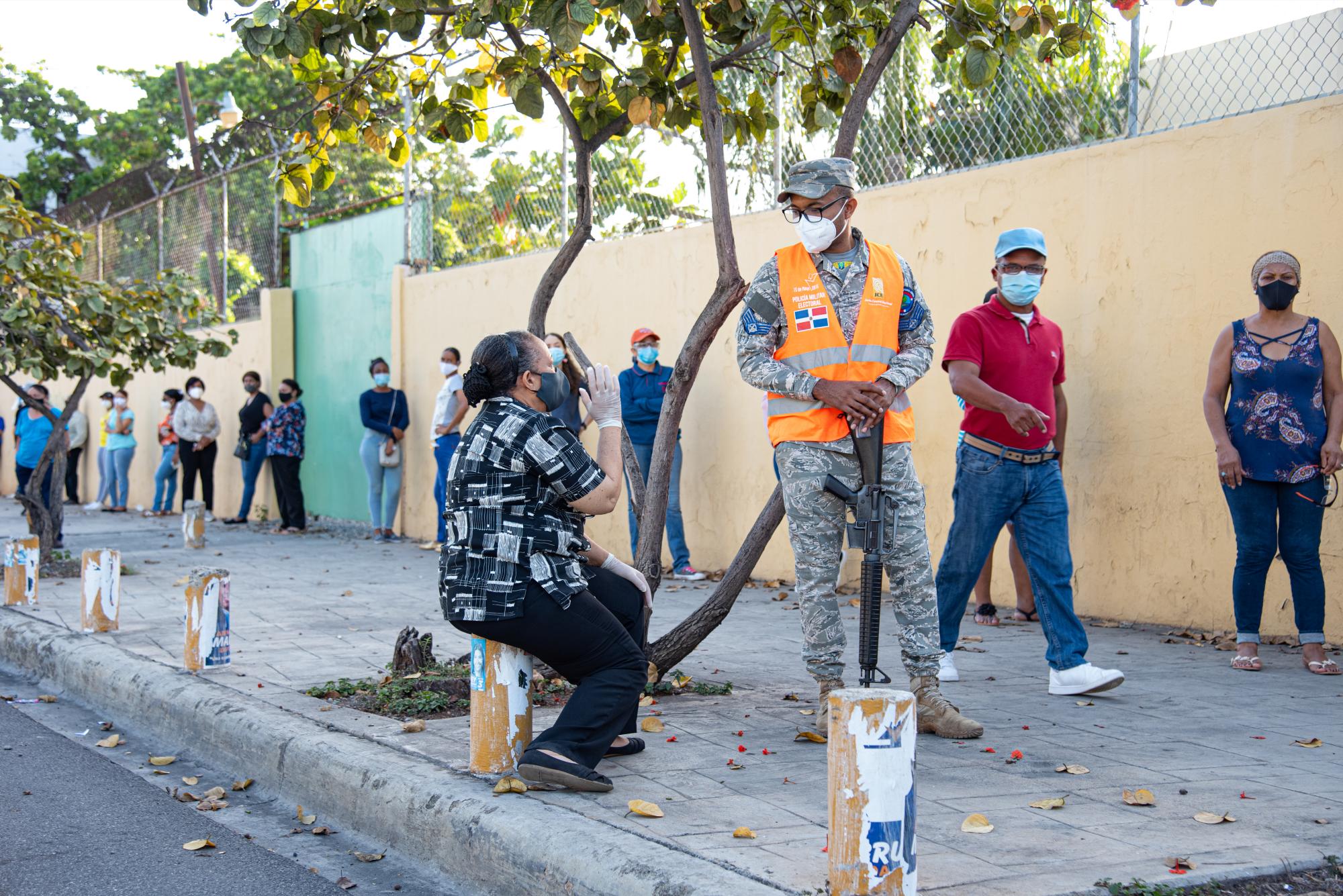 Una mujer de la tercera edad aguarda su turno guardando la distancia física sugerida por las autoridades (Dania Acevedo / Diario Libre)
