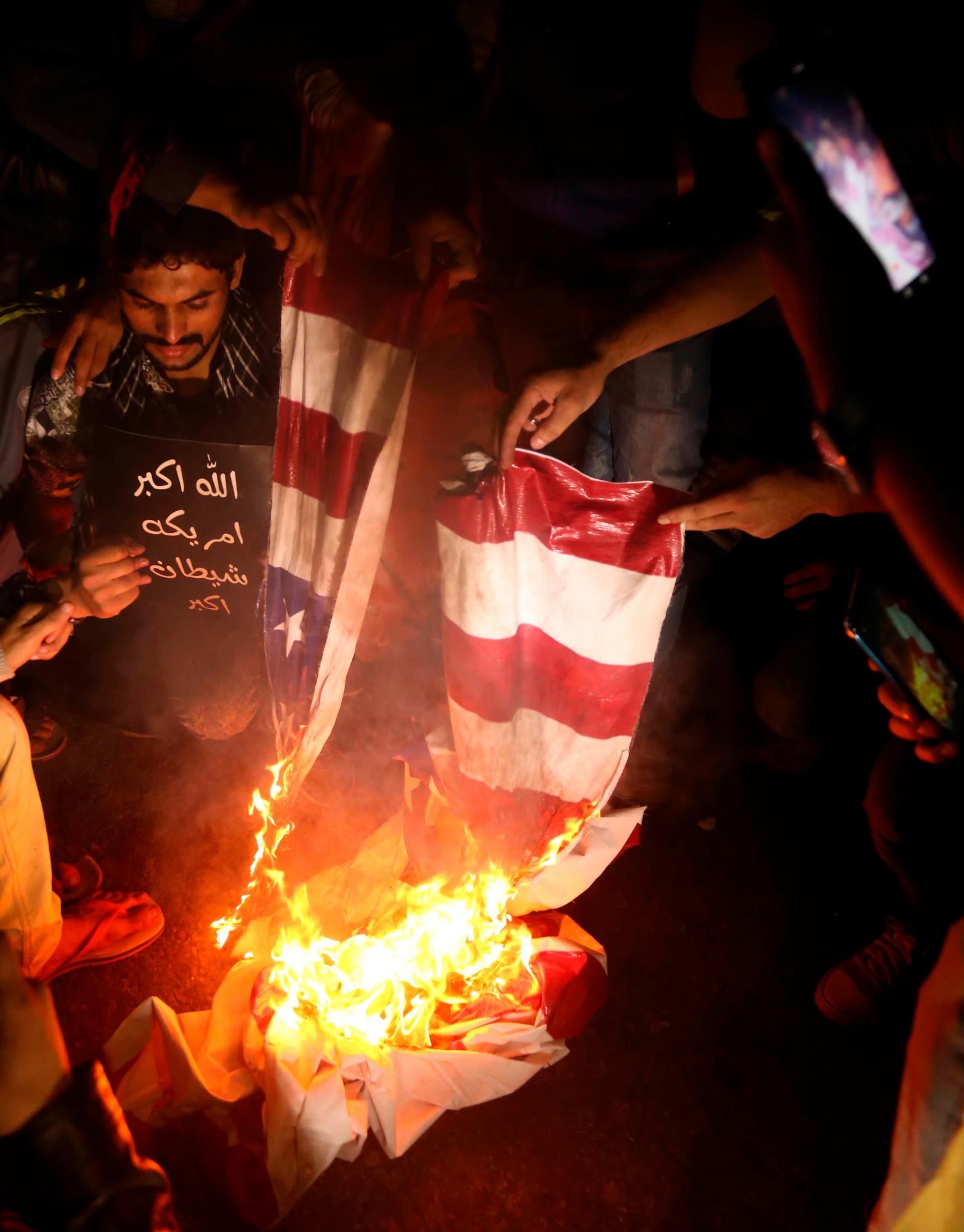 Los musulmanes chiítas paquistaníes queman un simulacro de bandera estadounidense mientras sostienen imágenes del general Qasem Soleimani, jefe de la élite de la Fuerza Quds de la Guardia Revolucionaria Islámica de Irán, durante una protesta contra Estados Unidos en Karachi, Pakistán, el 5 de enero de 2020. El general Qasem Soleimani, murió en un ataque aéreo el 03 de enero, en Bagdad, ordenado por el presidente de los Estados Unidos, dijo el Pentágono. El general Soleimani estaba a cargo de la estrategia de política exterior de Irán como jefe de la Fuerza Quds, un ala de élite del Cuerpo de la Guardia Revolucionaria Islámica, que Estados Unidos designó como organización terrorista. La Fuerza Quds domina sobre una serie de milicias chiítas en toda la región, desde el Líbano hasta Siria e Irak.