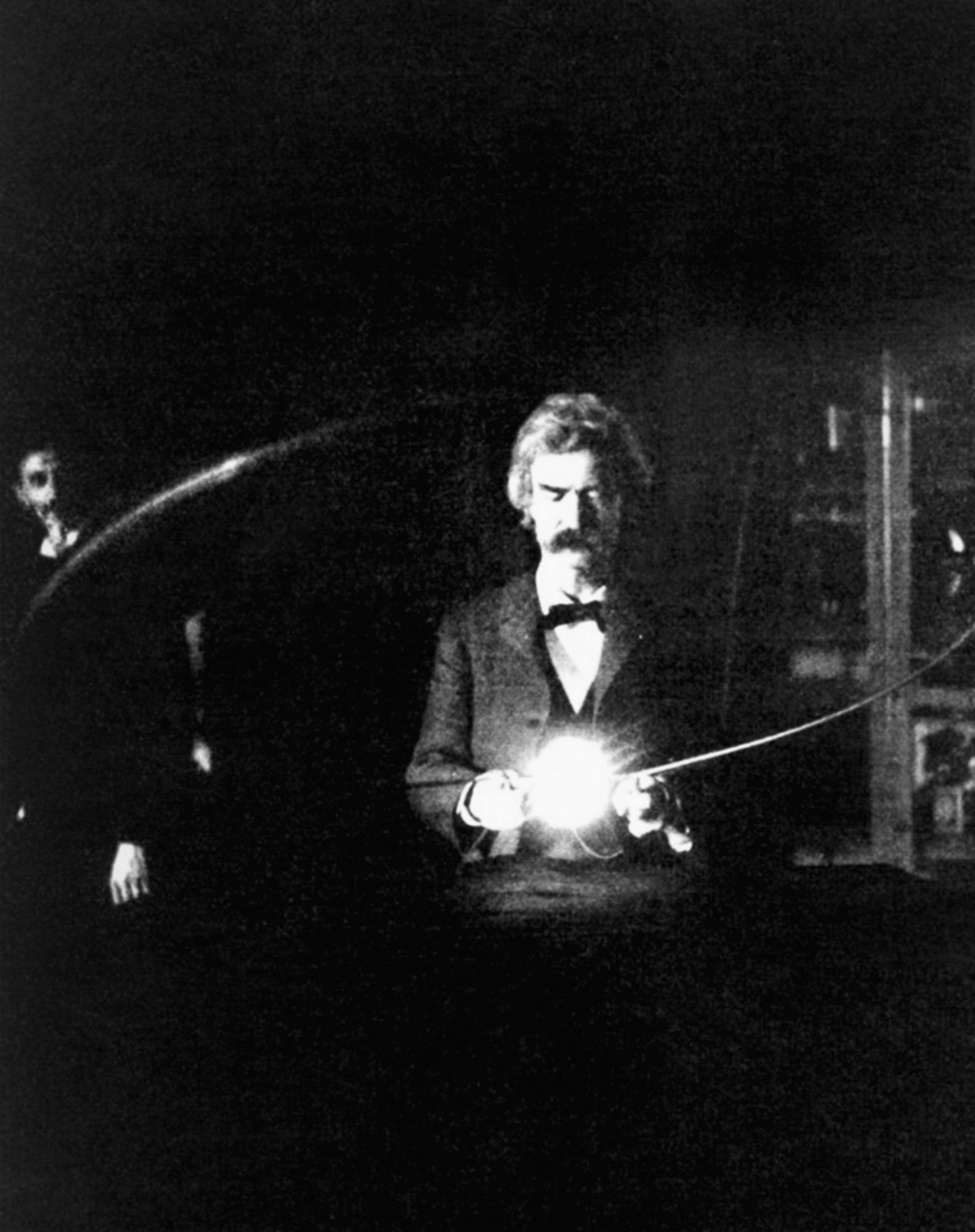 El amigo de Tesla, el escritor Mark Twain con una lámpara eléctrica. Al fondo el inventor. 