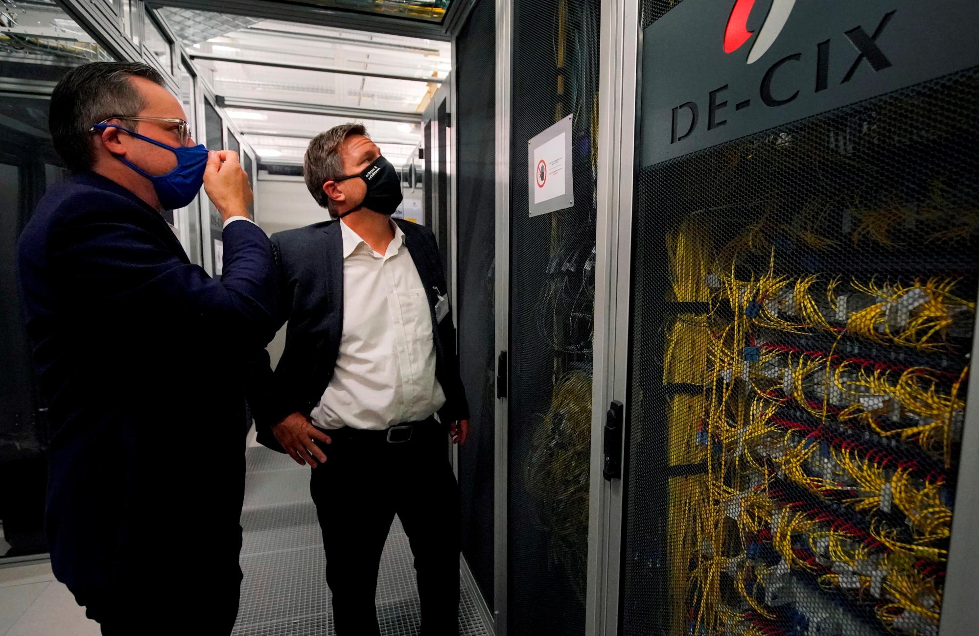 Dos políticos alemanes revisan un servidor de internet durante la crisis de la COVID-19. 