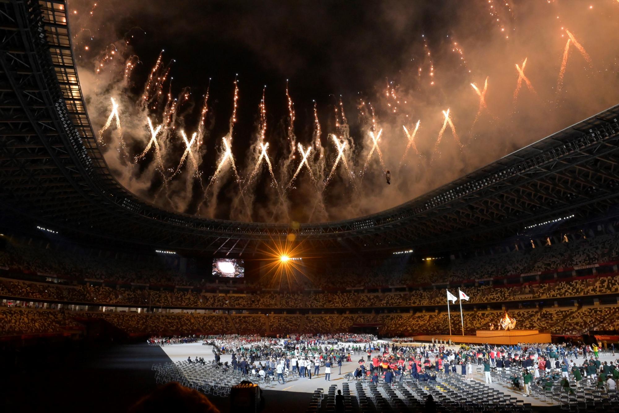 -FOTODELDÍA- TOKIO, 24/08/2021.- Atletas encienden el pebetero (d) durante la ceremonia inaugural de los Juegos Paralímpicos Tokio 2020, este martes en el Estadio Olímpico de Tokio. EFE/Szilard Koszticsak PROHIBIDO SU USO EN HUNGRÍA