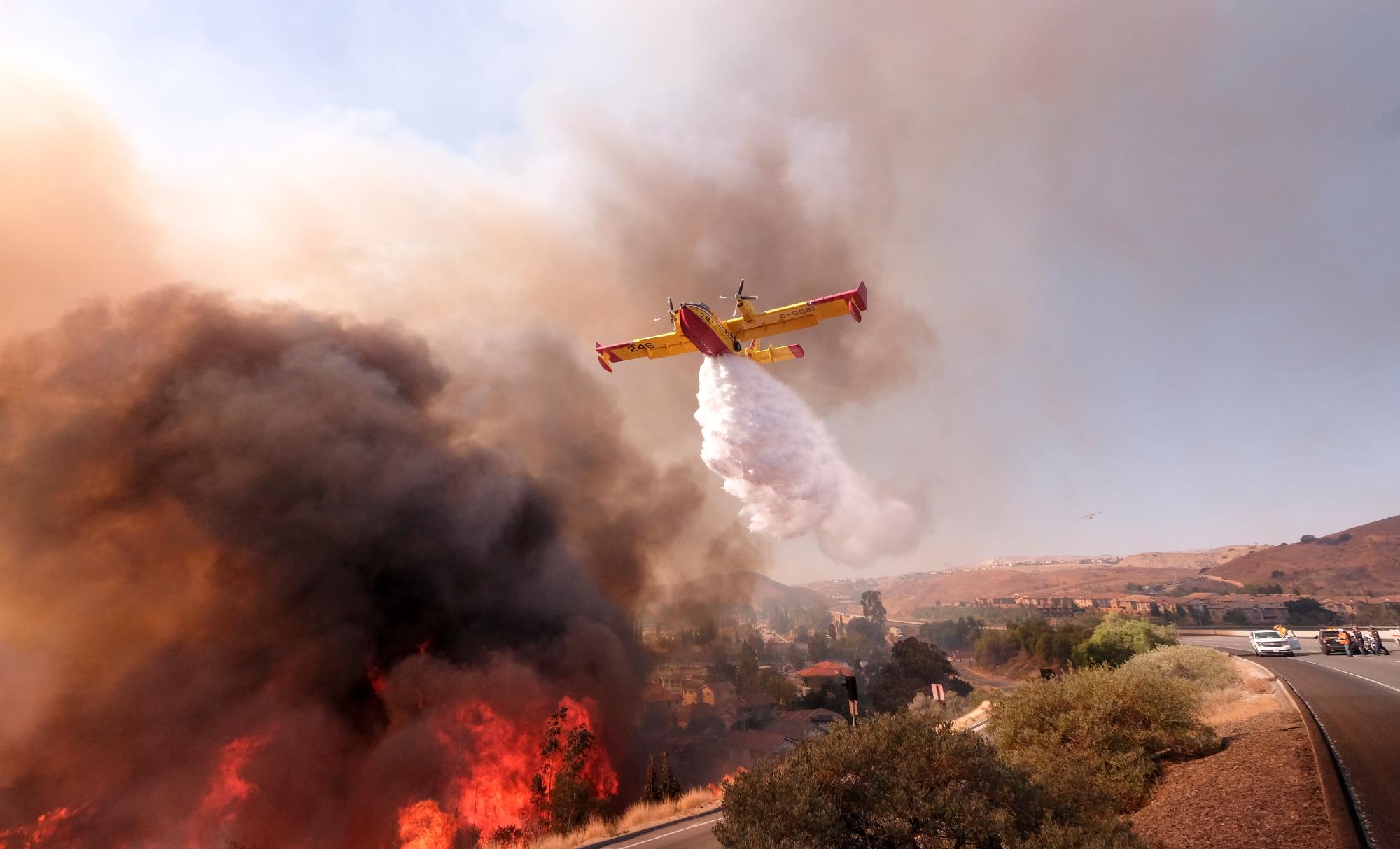 Un avión lanza agua para apagar los incendios en Paradise California.