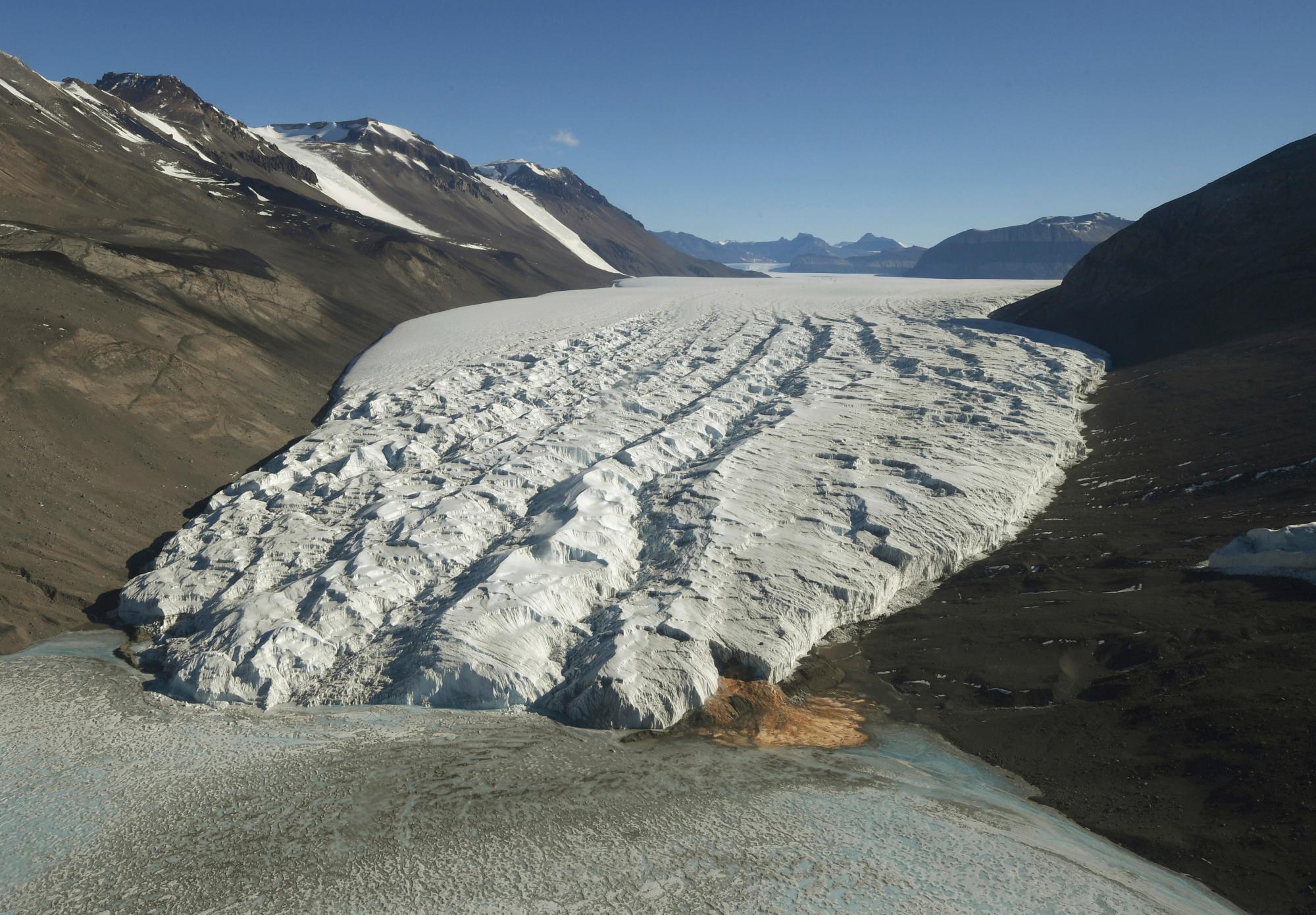 FILE- This Nov. 11, 2016, file photo shows the Taylor Glacier near McMurdo Station, Antarctica. According to a new study published Monday, Jan. 14, 2019, in Proceedings of the National Academy of Sciences, Antarctica is melting more than six times faster than it did in the 1980s. (Mark Ralston/Pool Photo via AP, File)