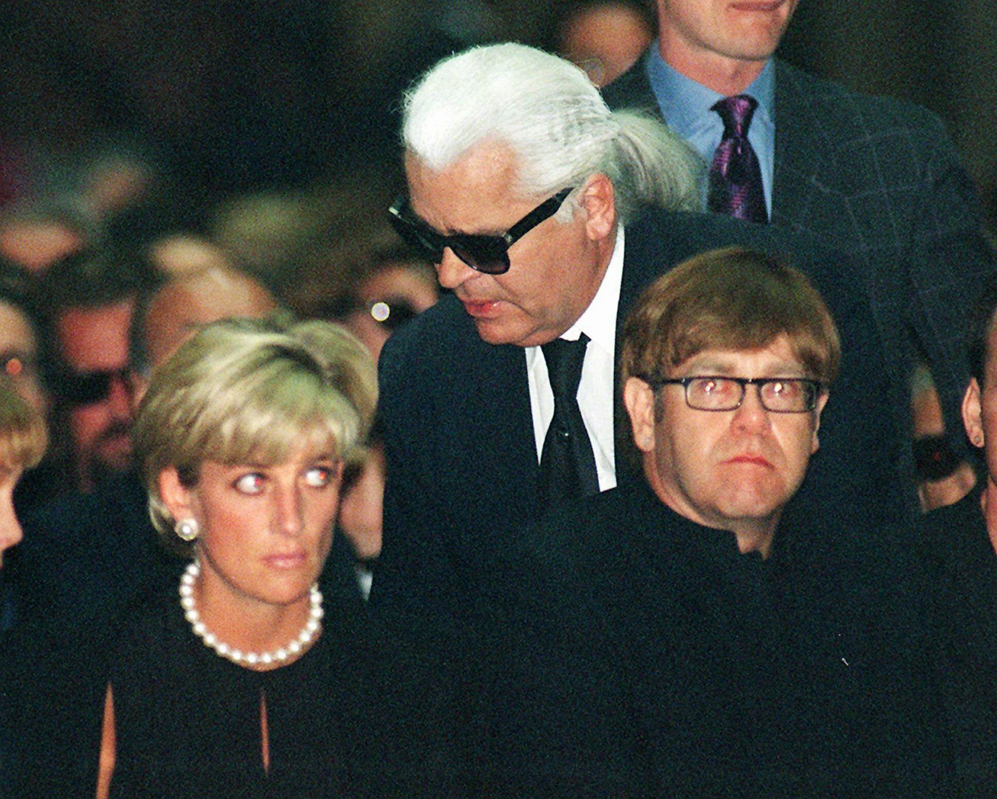 En foto de archivo del 22 de julio de 1997, Diana, princesa de Gales, el diseñador de moda alemán Karl Lagerfeld y la estrella pop británica Elton John, asisten a la misa conmemorativa de Gianni Versace, dentro de la catedral gótica de Milán, Italia.