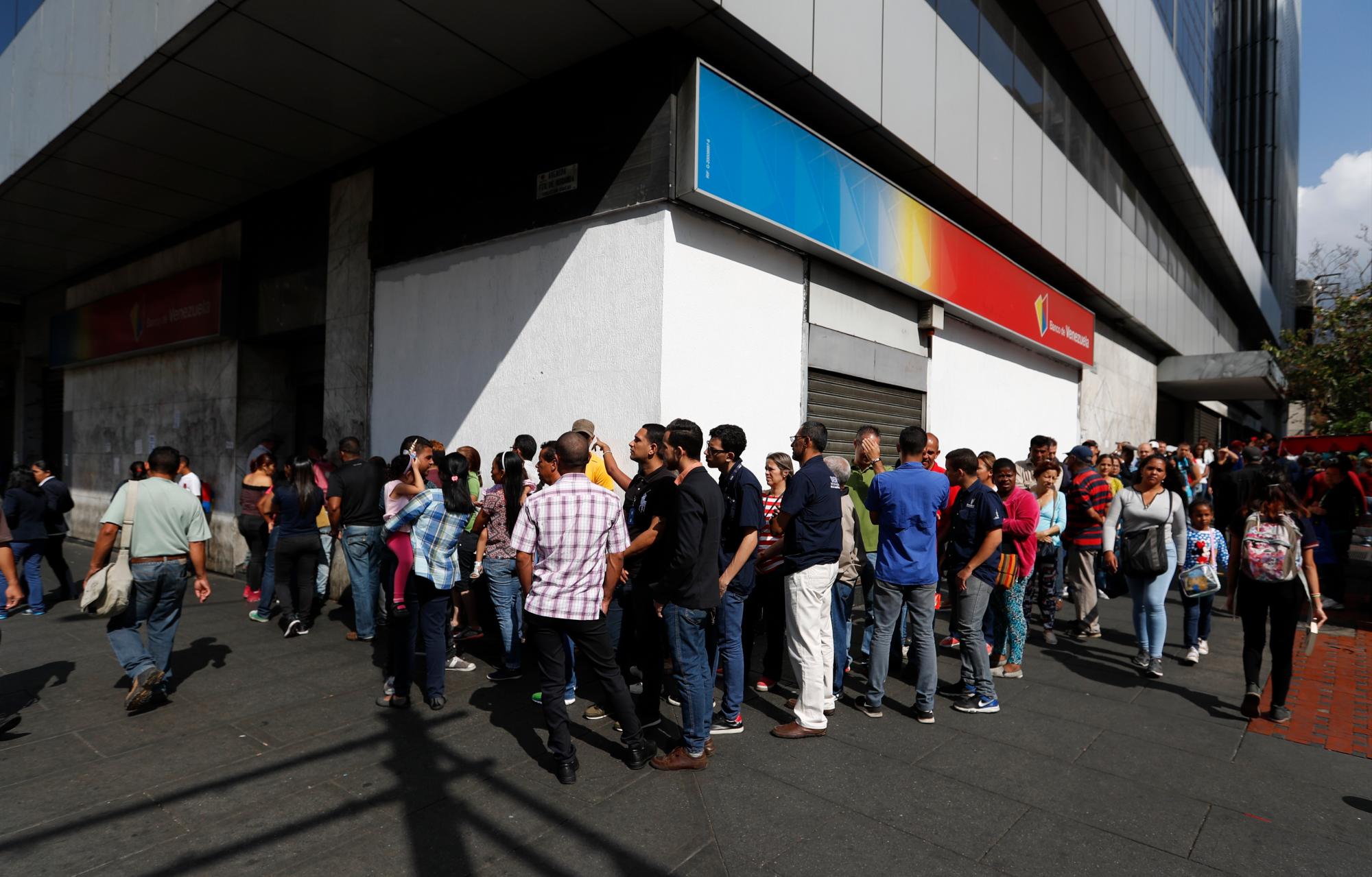 La gente hace fila frente a un banco en Caracas, Venezuela, el jueves 14 de marzo de 2019.