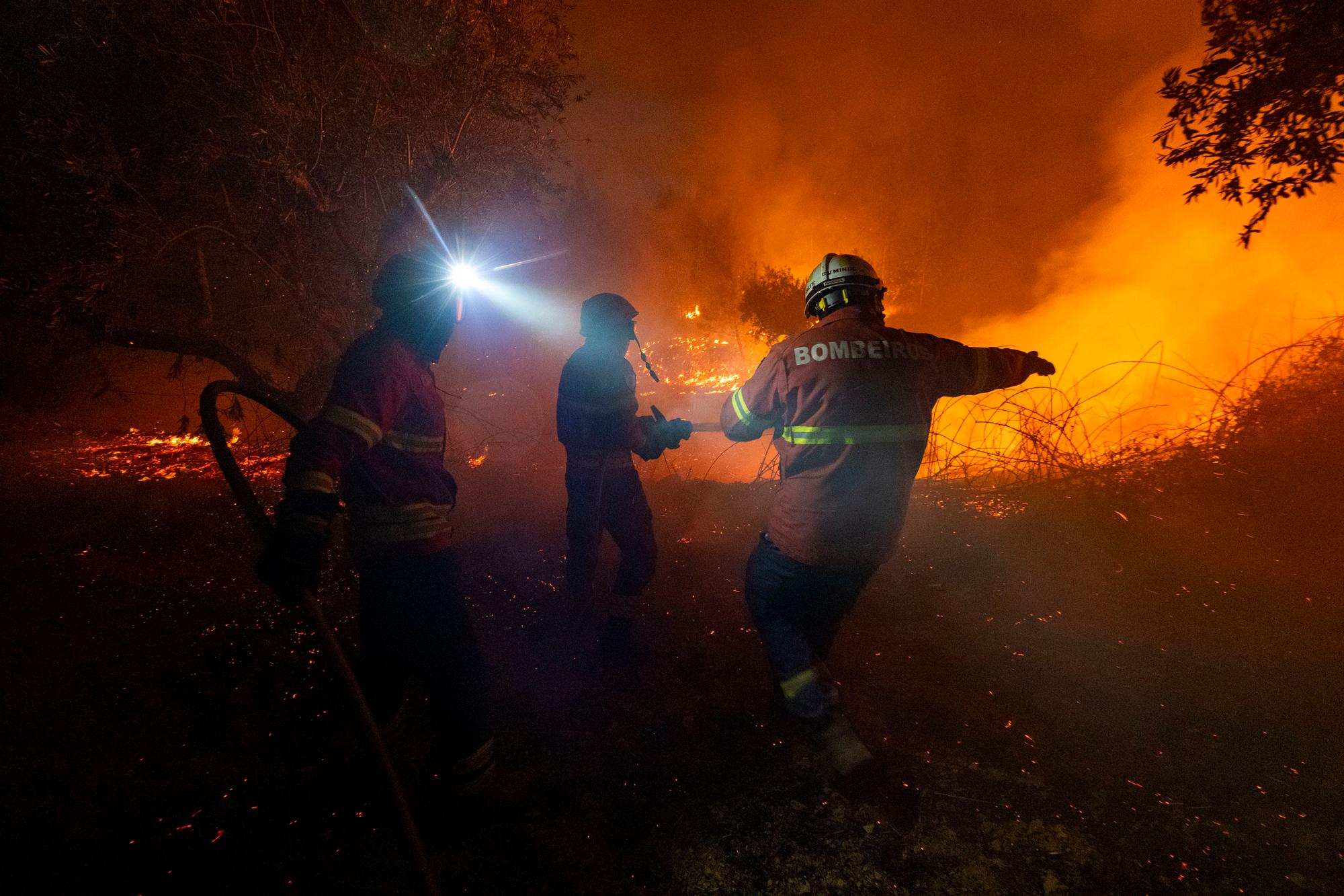 Los bomberos intentan apagar un incendio forestal cerca de la aldea de Cardigos, en el centro de Portugal, el domingo 21 de julio de 2019. Unos 1.800 bomberos luchaban por contener los incendios en el centro de Portugal que ya han herido a personas, incluidos varios bomberos, dijeron las autoridades el domingo.