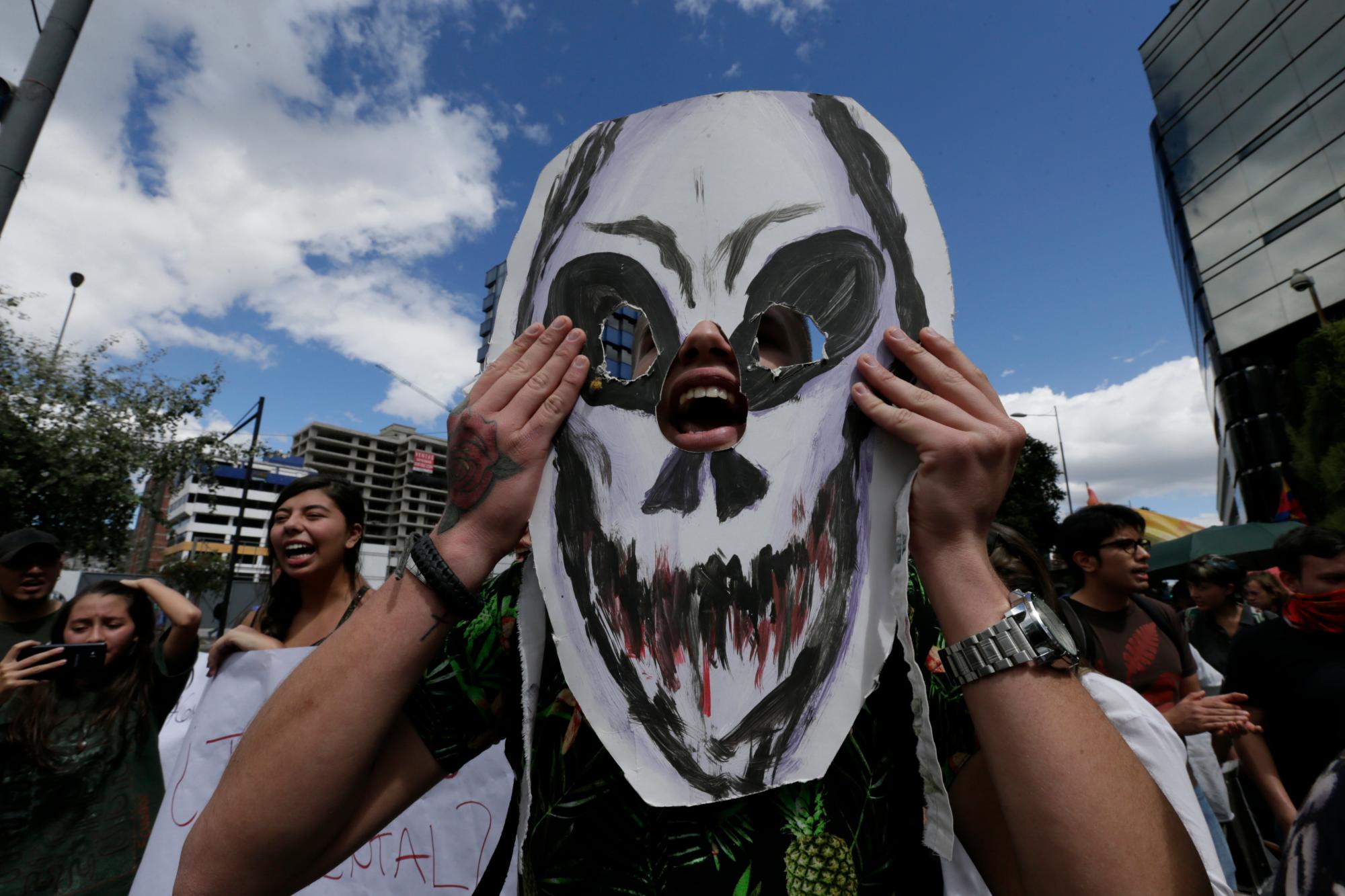 People gather outside the Brazilian embassy during a demonstration demanding something be done about the fires that have been breaking out at an unusual pace in Brazil this year, causing global alarm over deforestation in the Amazon region, in Quito, Ecuador, Friday, Aug. 23, 2019. Under increasing international pressure to contain fires sweeping parts of the Amazon, Brazilian President Jair Bolsonaro on Friday authorized use of the military to battle the massive blazes. 