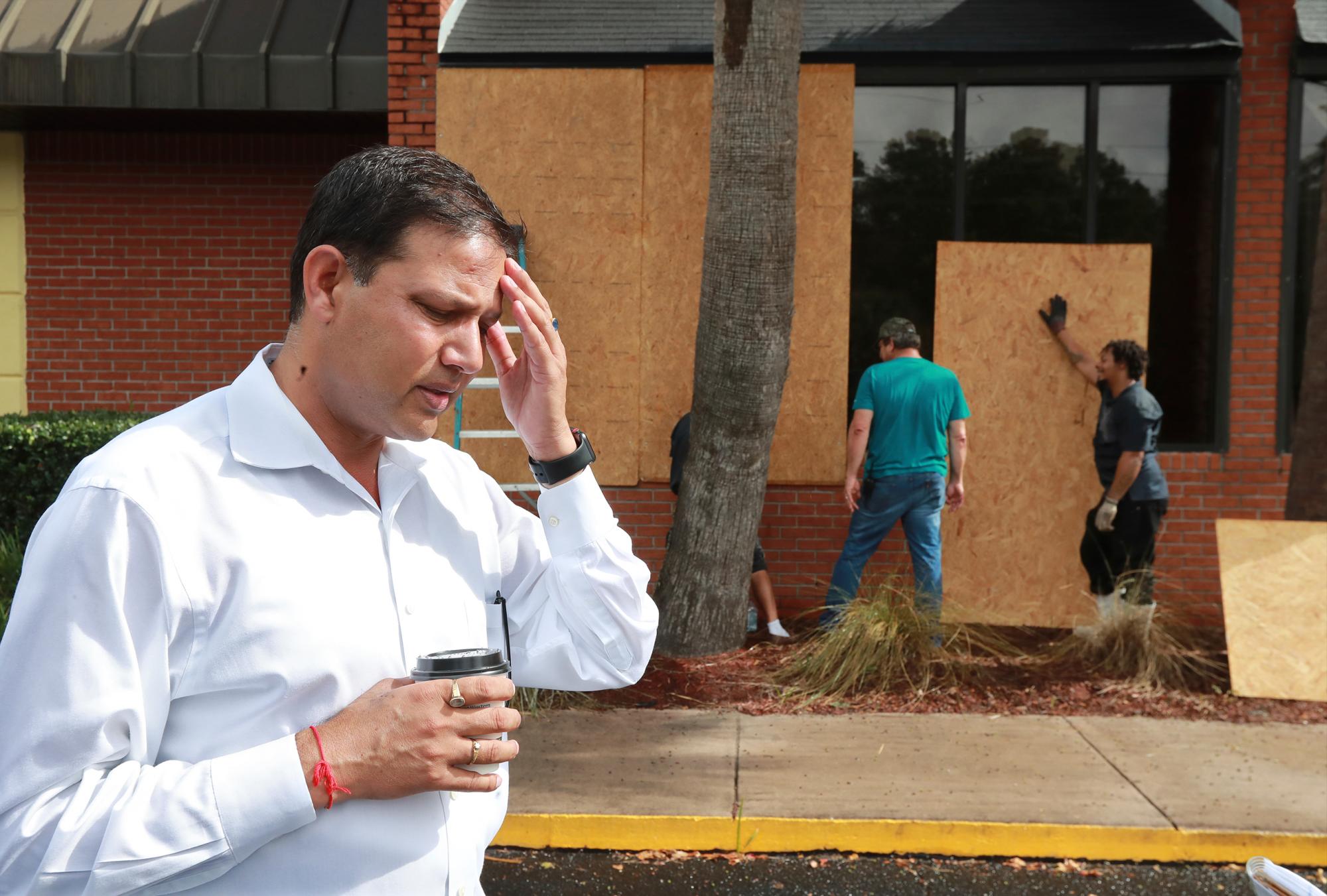 El propietario CB Yadav se encuentra afuera de su hotel Cumberland Inn & Suites mientras los empleados suben por las ventanas en preparación para el huracán Dorian el lunes 2 de septiembre de 2019, en St. Mary’s, Georgia. Se ha emitido una evacuación obligatoria para el área al este de la Interestatal 95 pero el hotel permanece abierto para empleados y trabajadores de emergencia. 