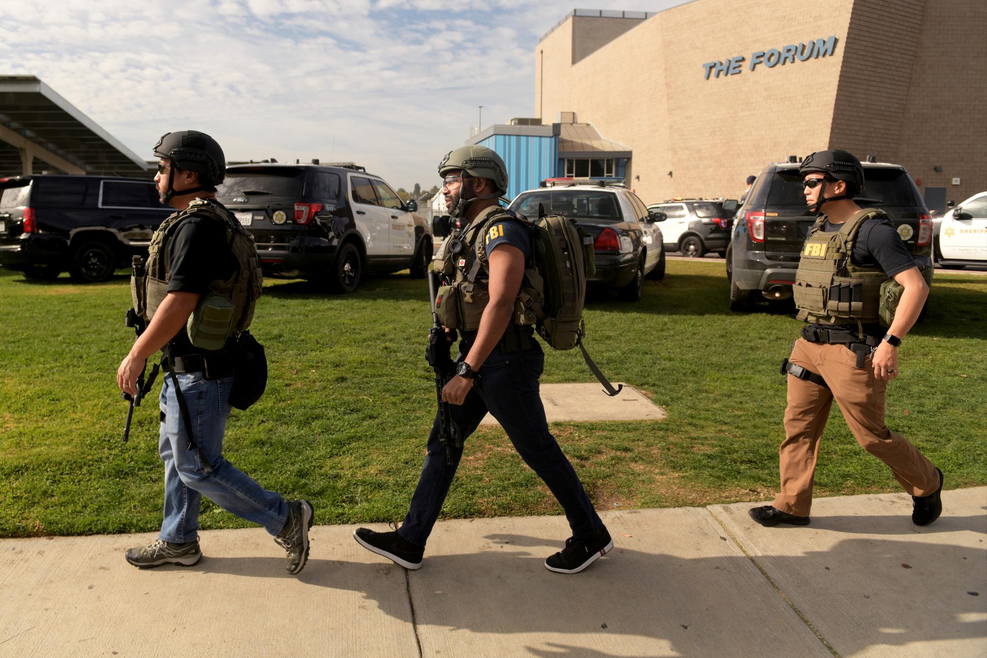 Funcionarios del FBI fuertemente armados inspeccionan la escena después de que un hombre armado abrió fuego en la escuela secundaria Saugus el jueves 14 de noviembre de 2019 en Santa Clarita, California 