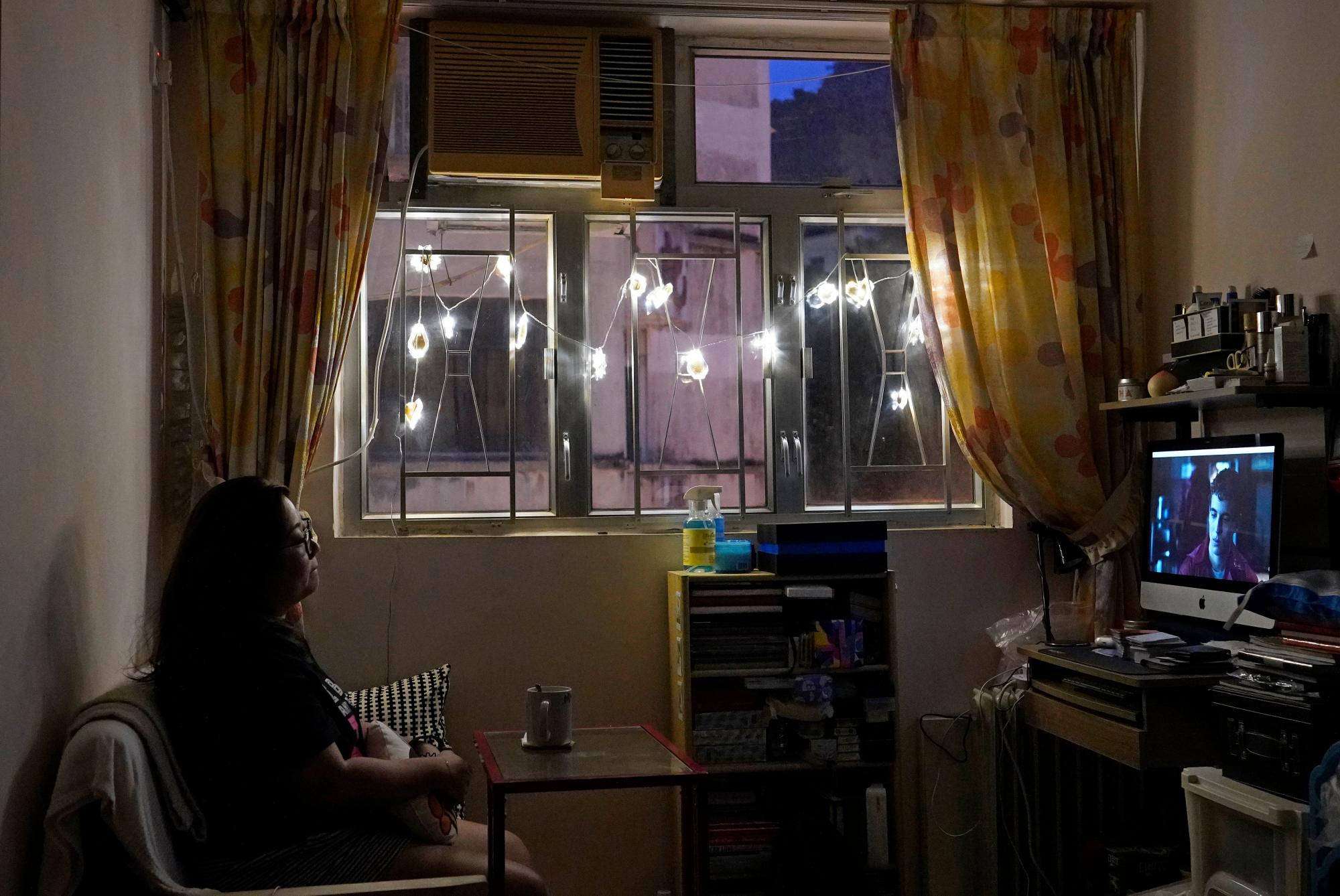 La reportera de Associated Press, Zen Soo, mira a Netflix en su sala de estar para relajarse, mientras sirve una cuarentena domiciliaria de 14 días obligatoria para todos los viajeros que regresaron a la ciudad desde el extranjero en Hong Kong, el 17 de abril de 2020. (Foto AP / Vincent Yu)