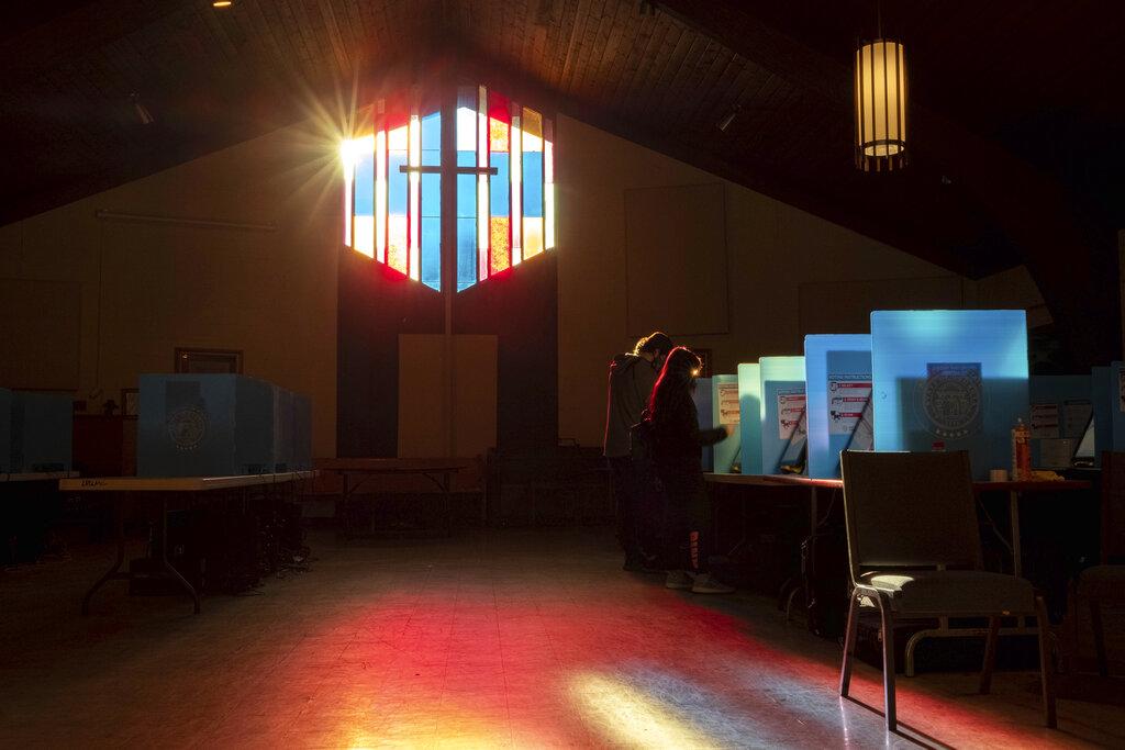 Dos electores depositan su voto en Lawrenceville Road United Methodist Church de Tucker, Georgia. (AP Photo/Ben Gray)