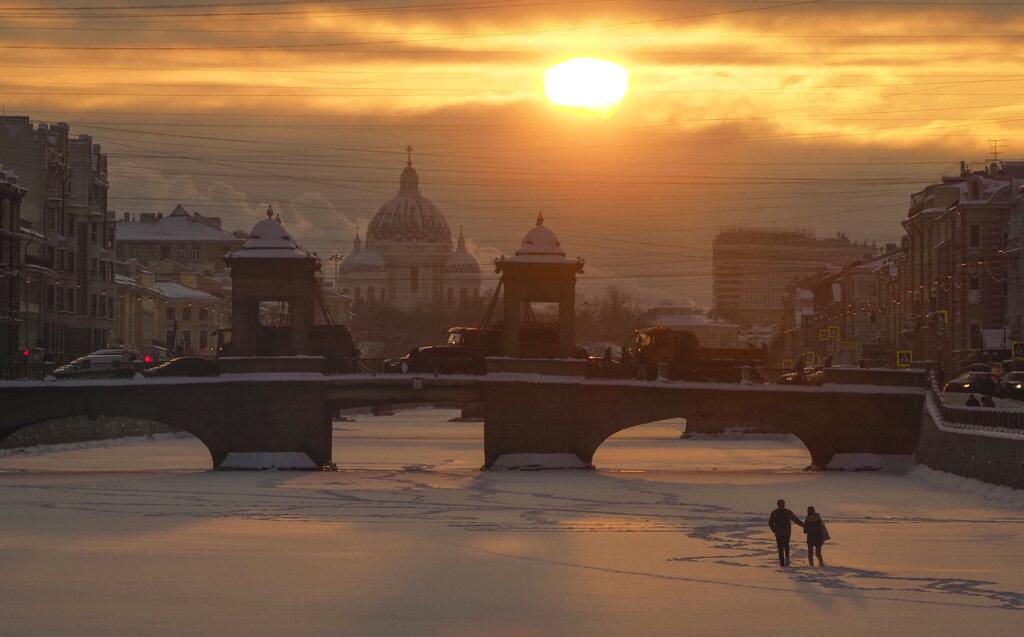 Una pareja camina en la superficie congelada del Río Fotanka en San Petesburgo, Rusia. (AP Photo/Dmitri Lovetsky)