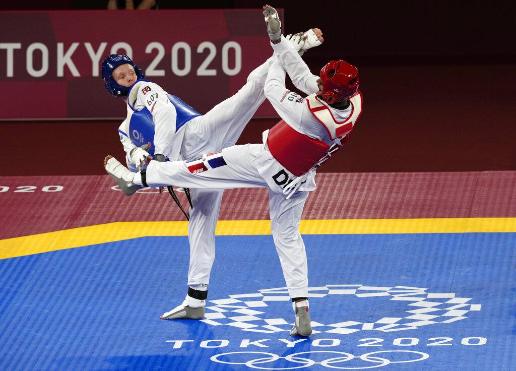 Nikita Rafalovich de Uzbekistán, izquierda, Moisés Hernández de República Dominicana durante el partido de 80 kg masculino de taekwondo en los Juegos Olímpicos de Verano de 2020, el lunes 26 de julio de 2021, en Tokio, Japón. (Foto AP / Themba Hadebe)