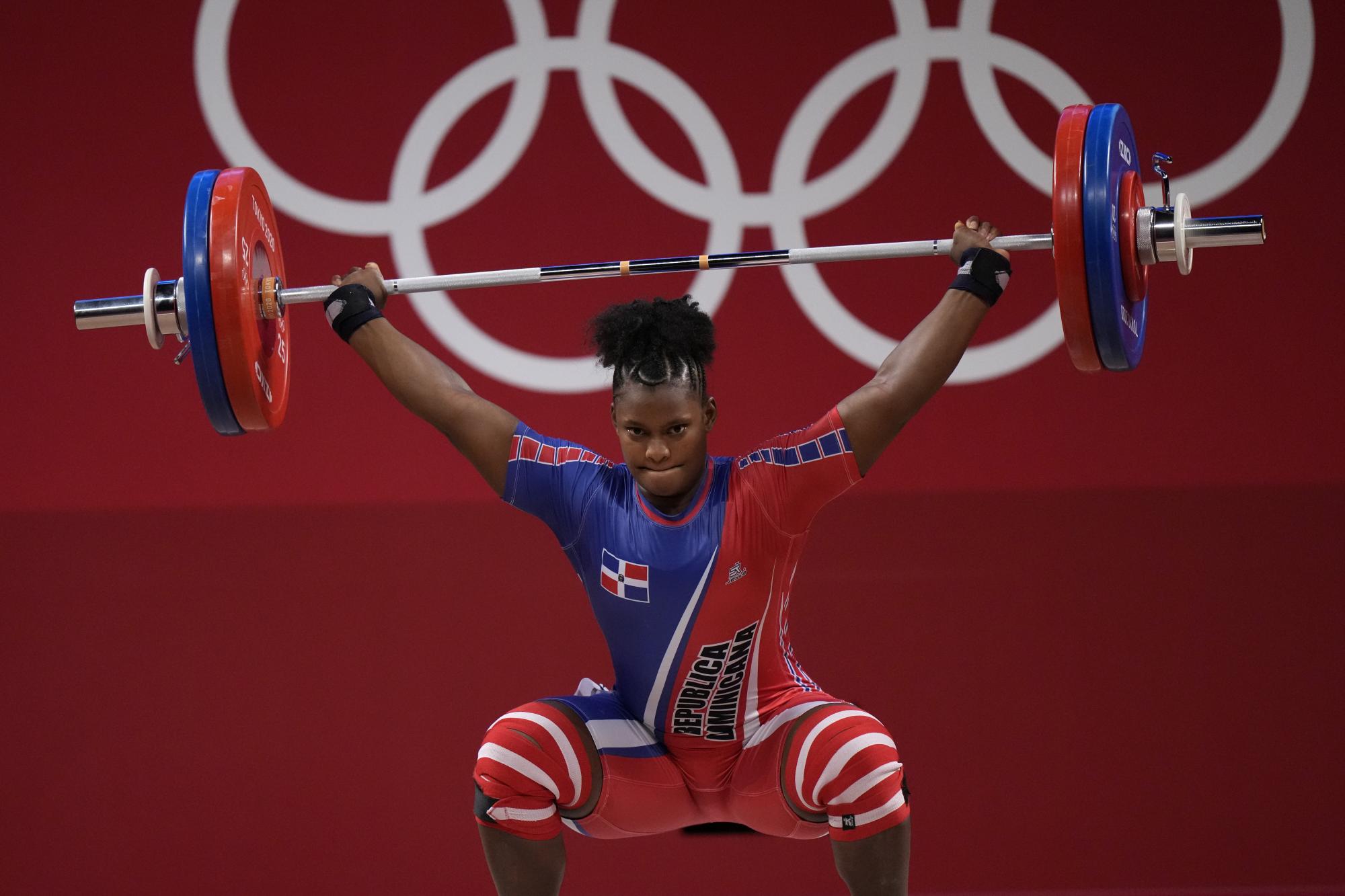 Crismery Dominga Santana Peguero of Dominican Republic competes in the womens 87kg weightlifting event at the 2020 Summer Olympics, Monday, Aug. 2, 2021, in Tokyo, Japan. (AP Photo/Luca Bruno)