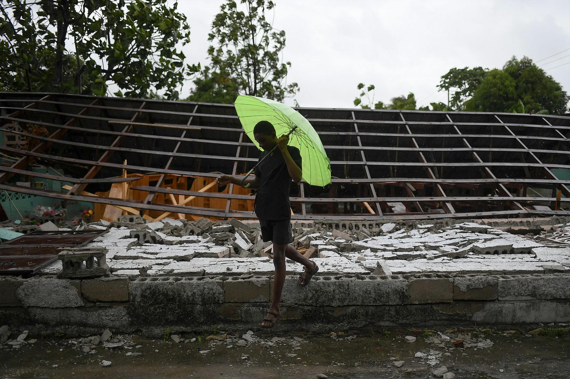 Un hombre pasa junto a una iglesia destruida por el terremoto la mañana después de que la tormenta tropical Grace azotara Trou Mahot, Haití, el martes 17 de agosto de 2021, tres días después de un terremoto de magnitud 7.2. (Foto AP / Matias Delacroix)