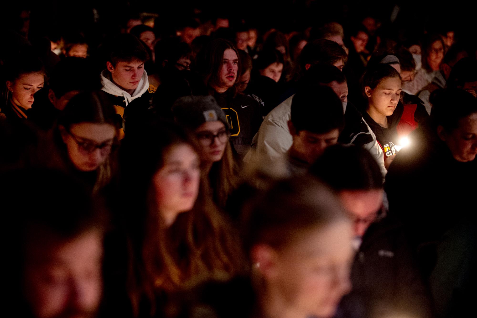 La estudiante de segundo año de Oxford High School, Allison Hepp, de 15 años, sostiene una vela mientras inclina la cabeza en oración durante una vigilia después de los tiroteos en Oxford High School, el martes 30 de noviembre de 2021, en LakePoint Community Church en Oxford, Michigan (Jake May / The Flint Journal vía AP)