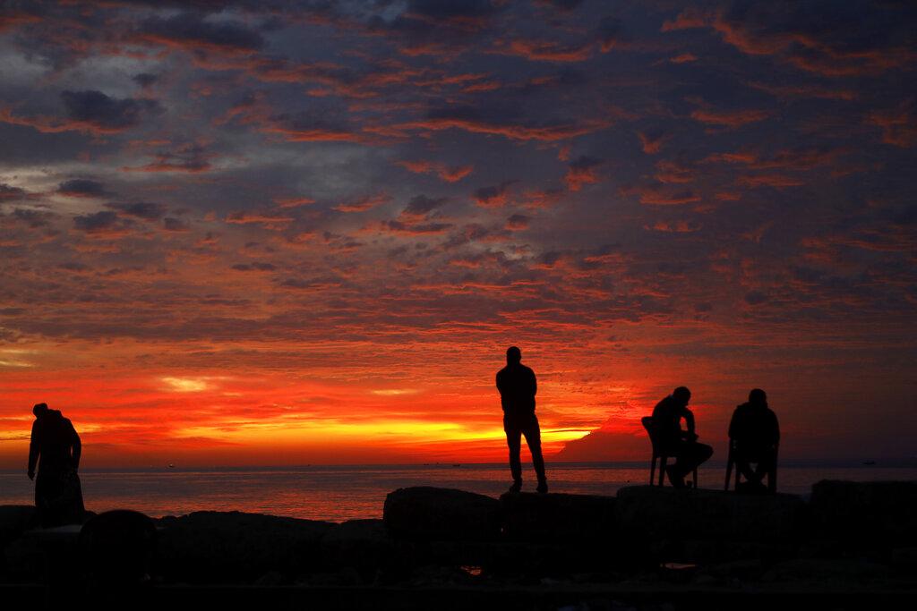 Palestinians enjoy during the sunset on the beach, in Gaza City, Saturday, Dec. 4 , 2021. The beach is one of the few open public spaces in this densely populated city. (AP Photo/Hatem Moussa) Palestinians enjoy during the sunset on the beach, in Gaza City, Saturday, Dec. 4 , 2021. The beach is one of the few open public spaces in this densely populated city. (AP Photo/Hatem Moussa)