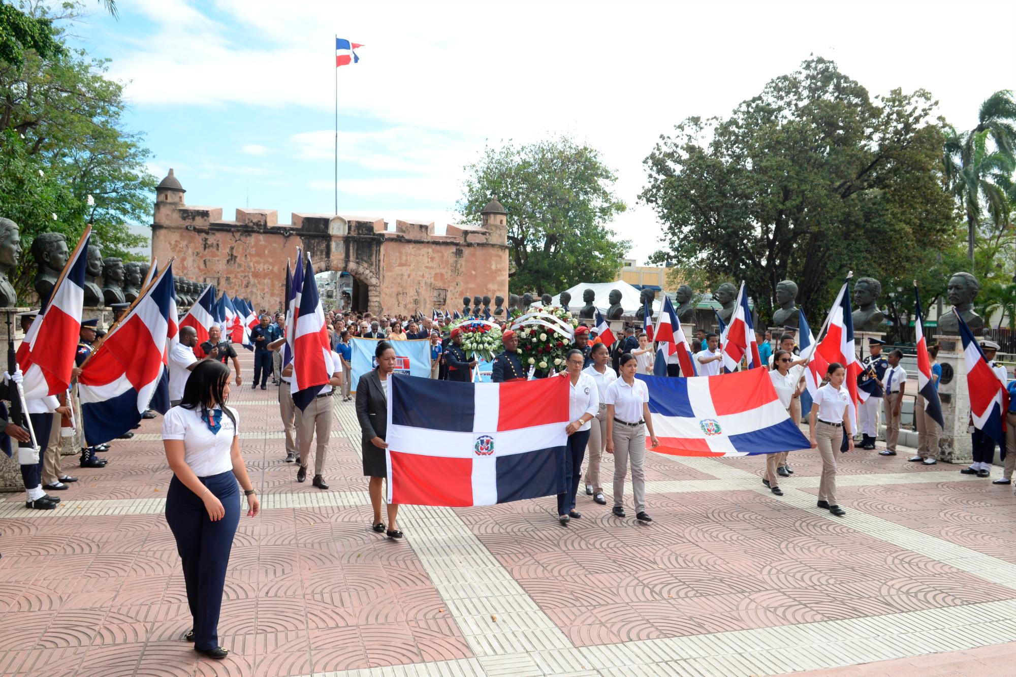 Estudiantes portan banderas durante el acto de conmemoración