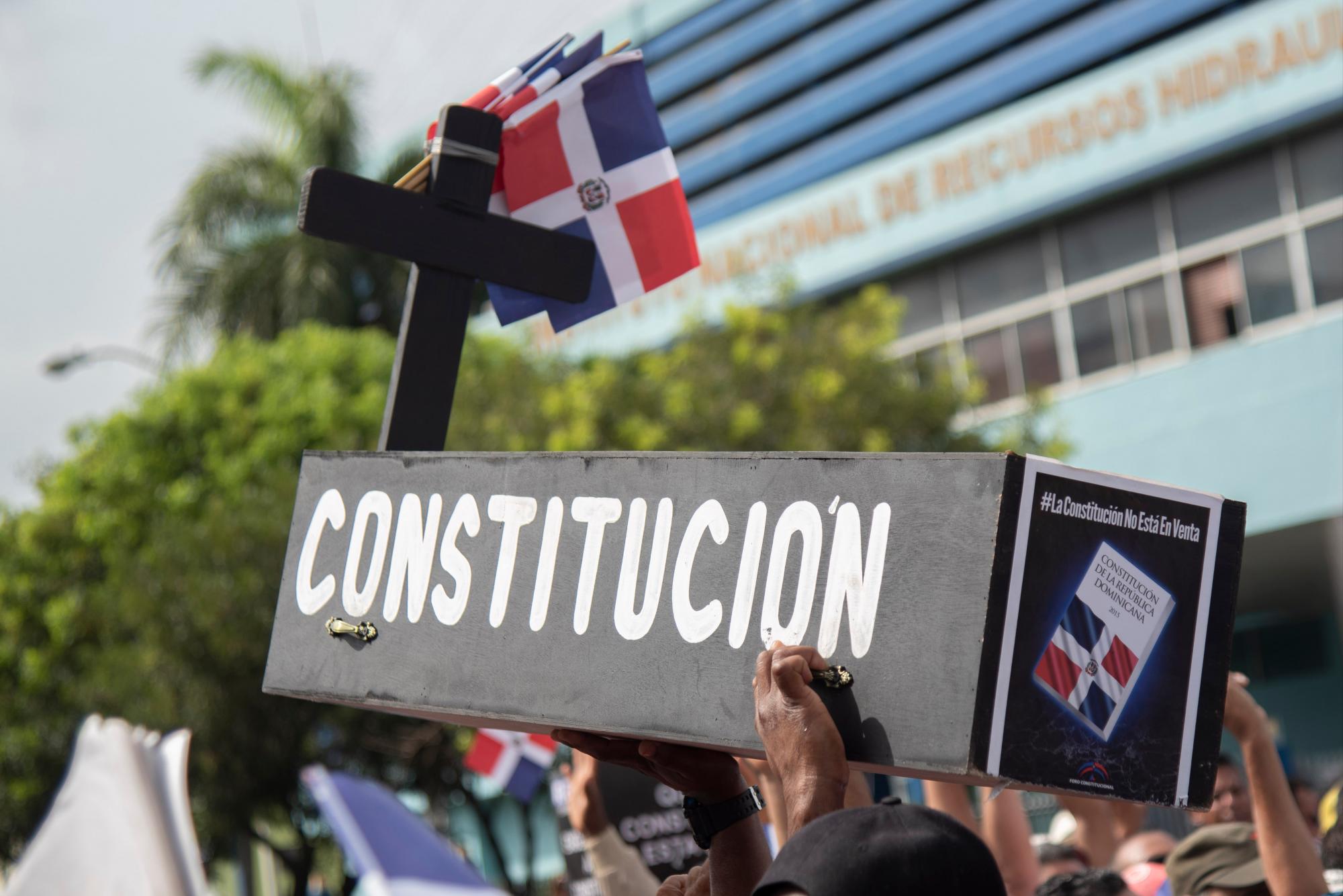 Manifestantes cargan un ataúd simbolizando la Constitución Dominicana durante una protesta frente al Congreso de la República en contra de una posible reforma. 
