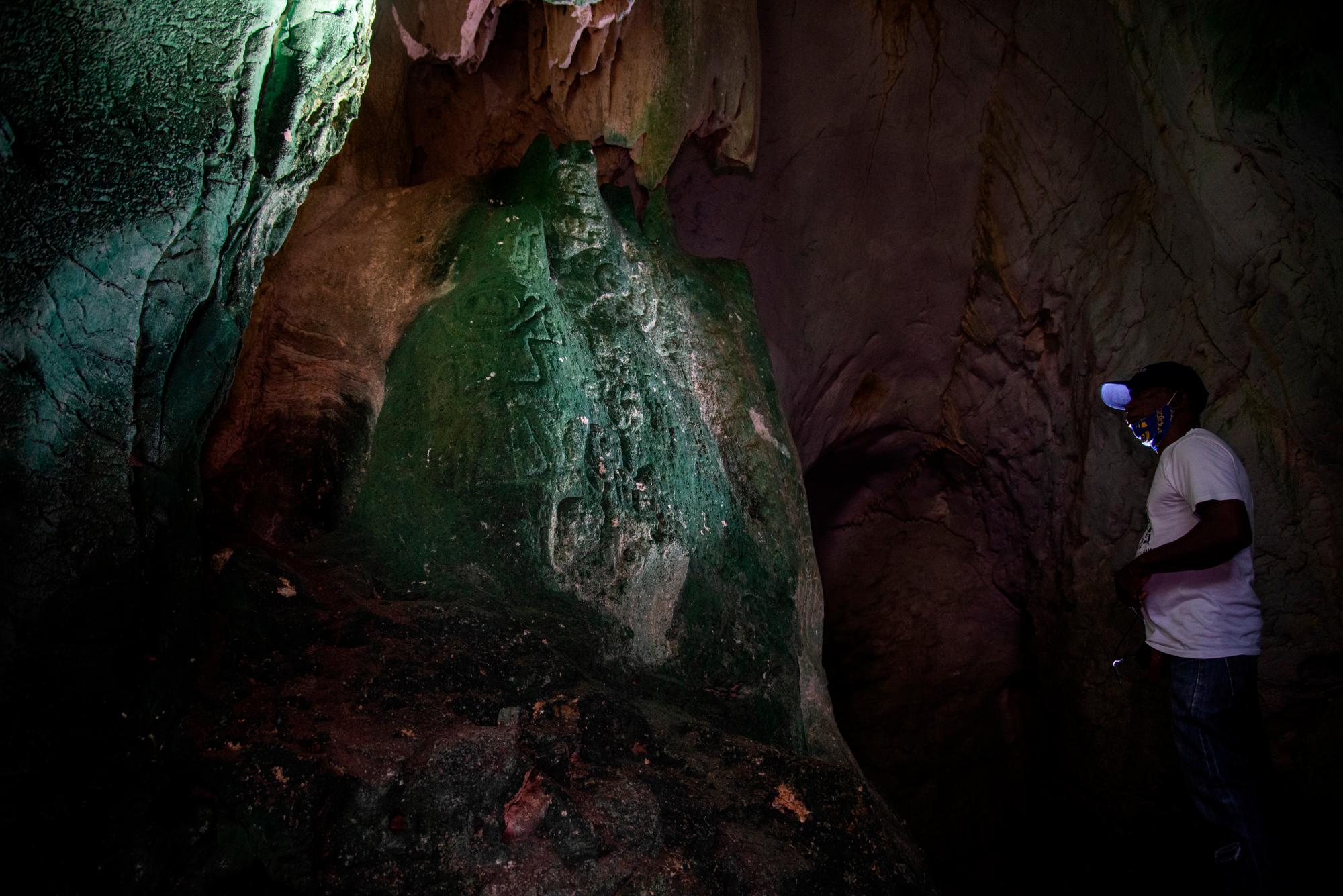 Victor Casitllo, guía y miembro de la Fundación Cuevas del Pomier, muestra diferentes petroglifos en la Cueva No. 4.