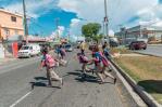 Niños cruzan calle corriendo por falta de un puente peatonal frente a su escuela